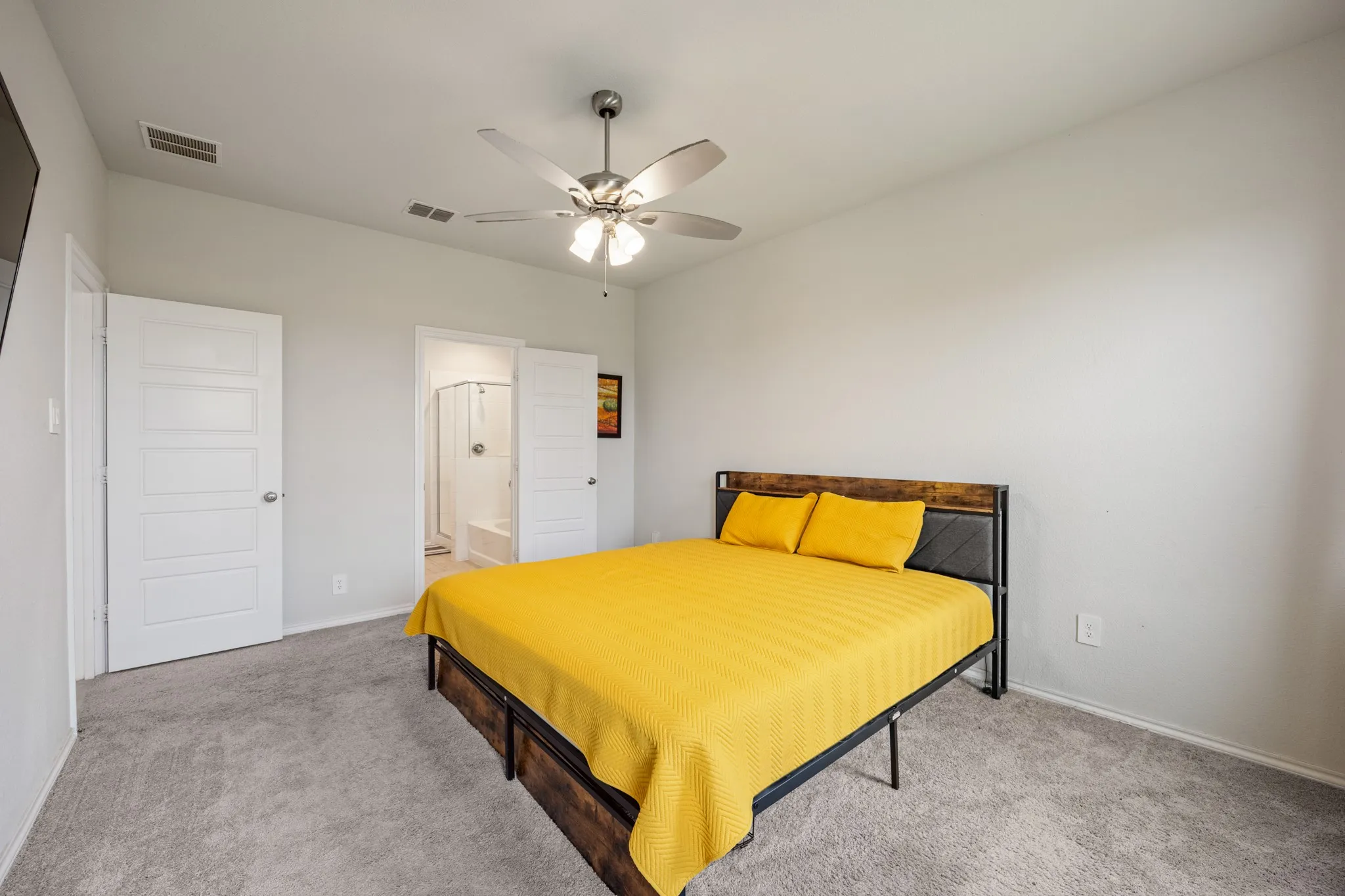 Recessed lighting, ceiling fan with light fixture, light gray walls, gray carpet, and white paneled doors