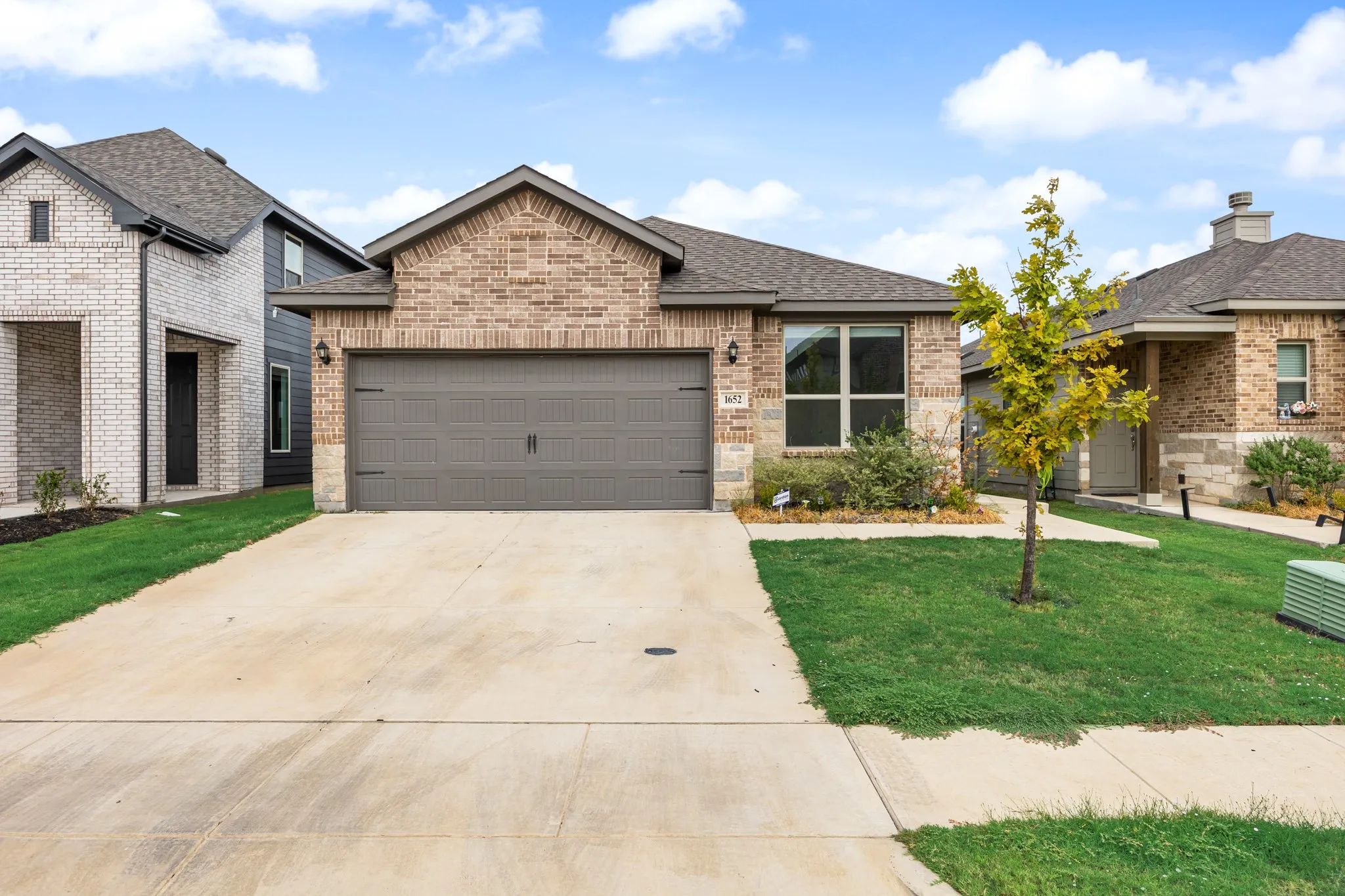 Brick and stone exterior with a two-car garage