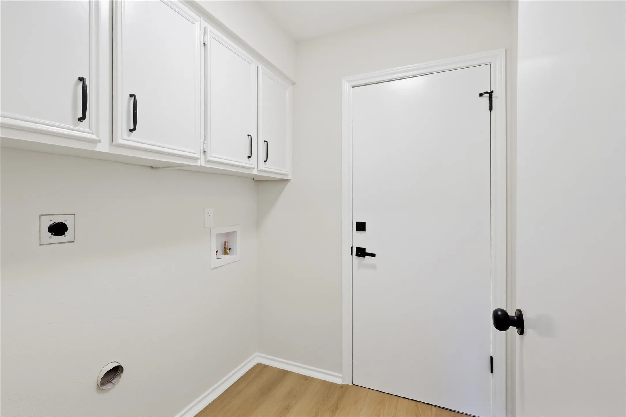 White shaker-style cabinetry with matte black hardware