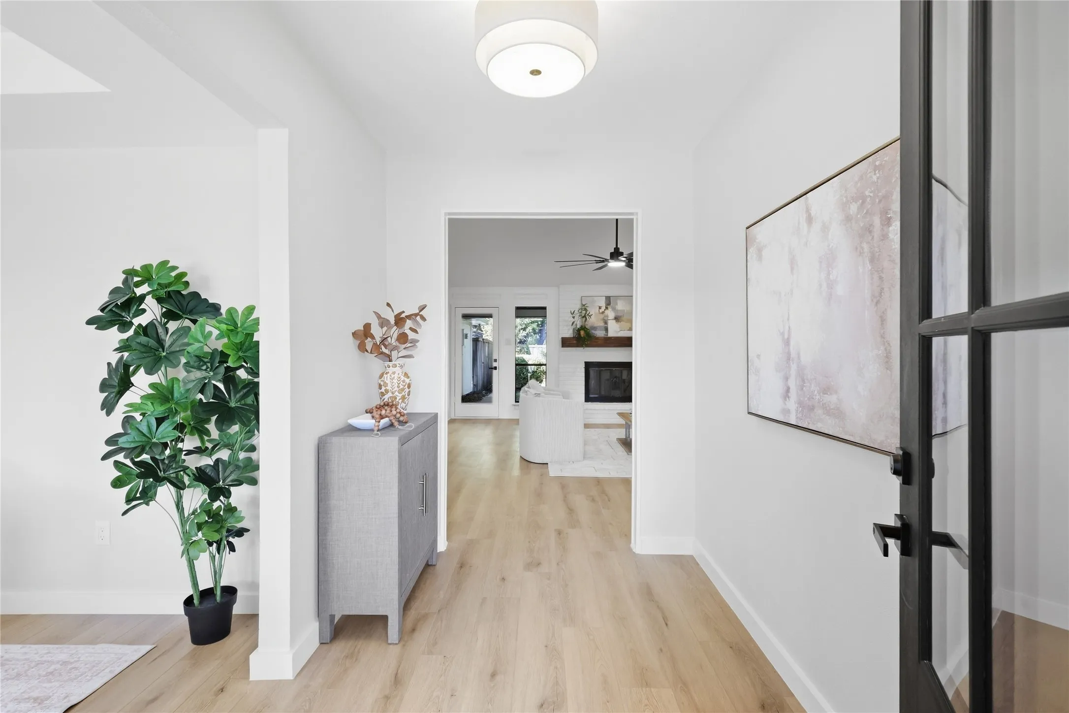 Bright entryway with wood-finish flooring and a contemporary flush mount light fixture