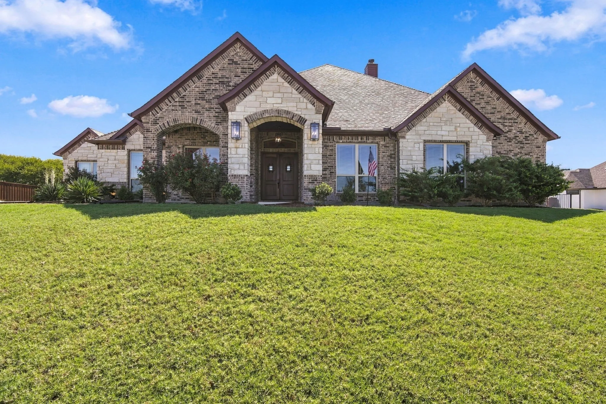 Beautiful Mystic Oak custom home. Brick and stone exterior with gables.