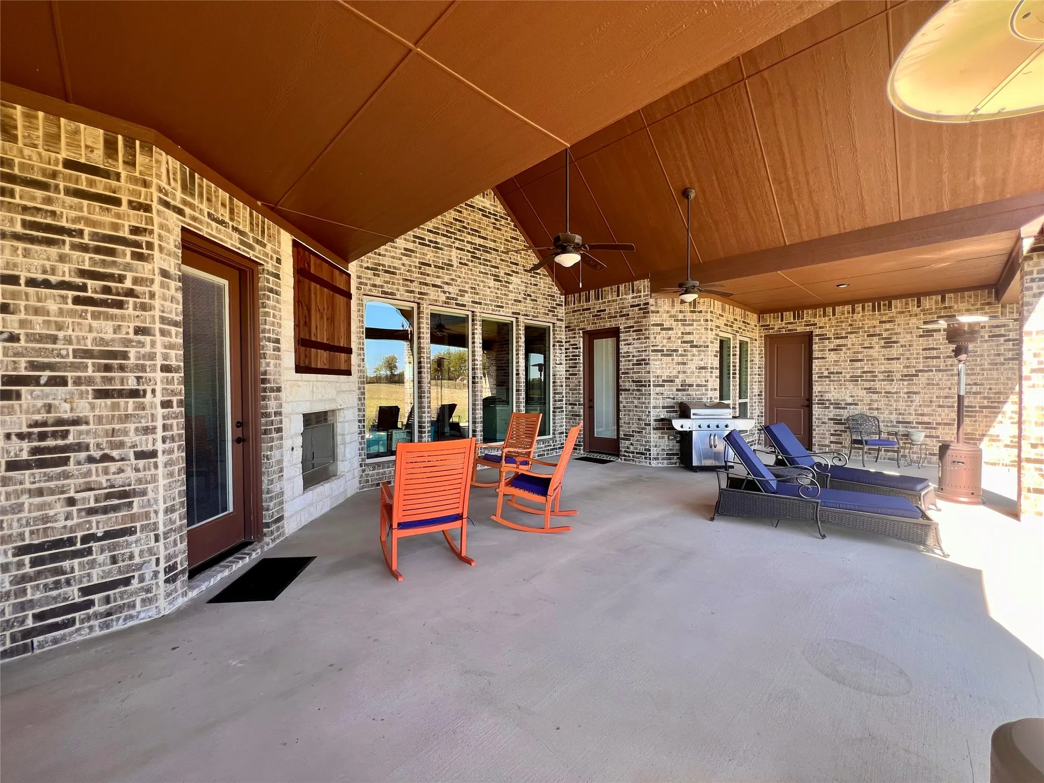 You'll love the covered patio featuring a stone fireplace, TV Cabinet with Cedar doors and multiple ceiling fans.