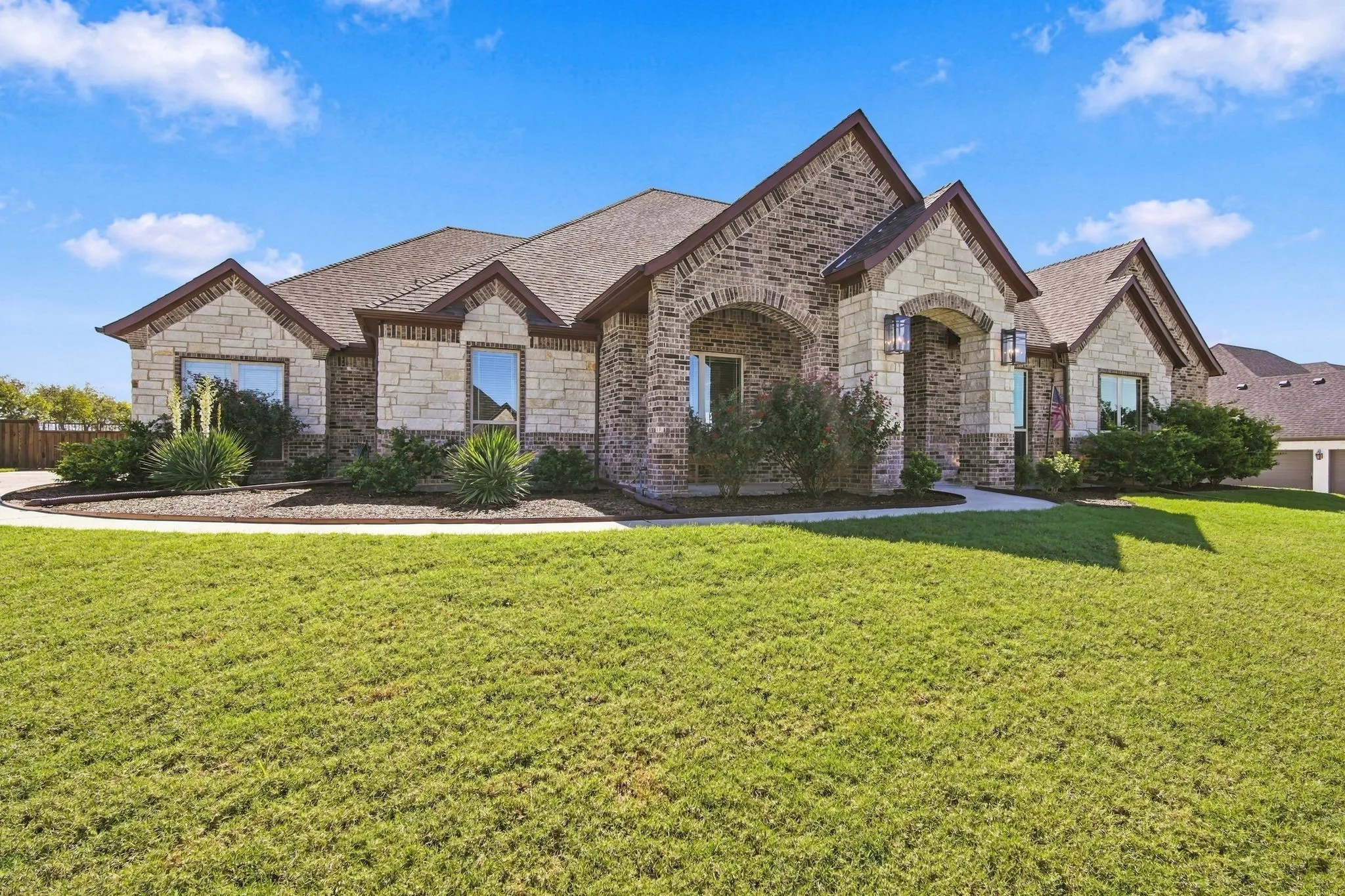 Established landscaping leads you to the covered front porch.