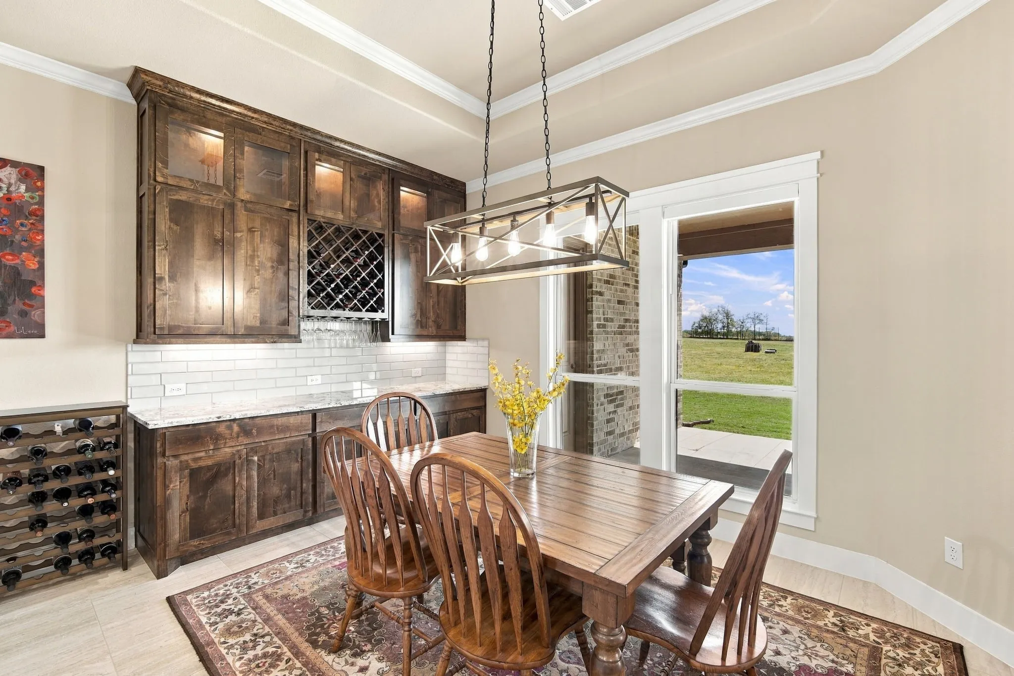 Built-in cabinetry with integrated wine storage, under-cabinet lighting, lighted display cabinets and subway tile backsplash Trey ceiling with crown molding. Electric shades.