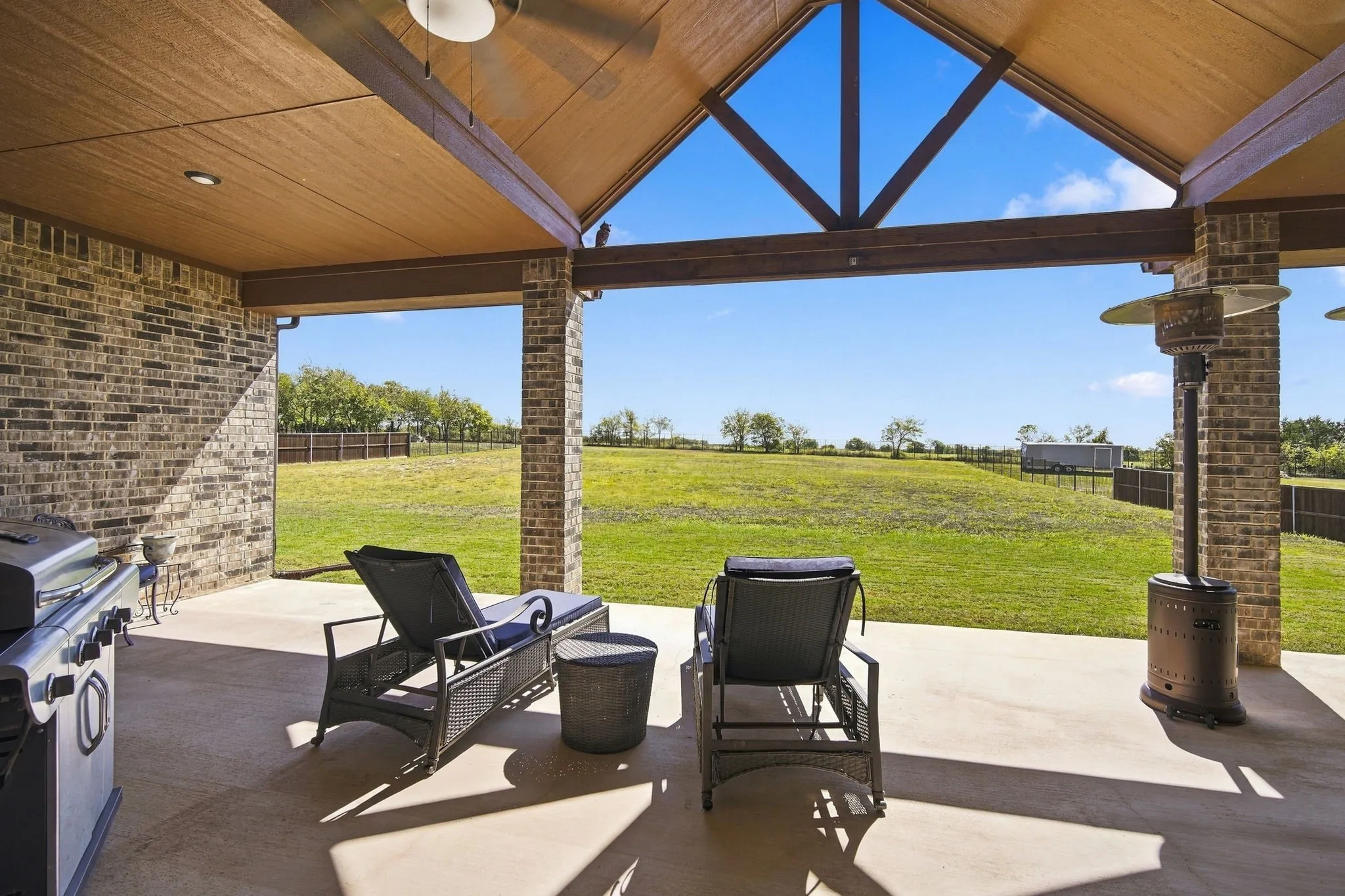So much space on this covered patio with a vaulted ceiling. You could add a dining table to the space too!