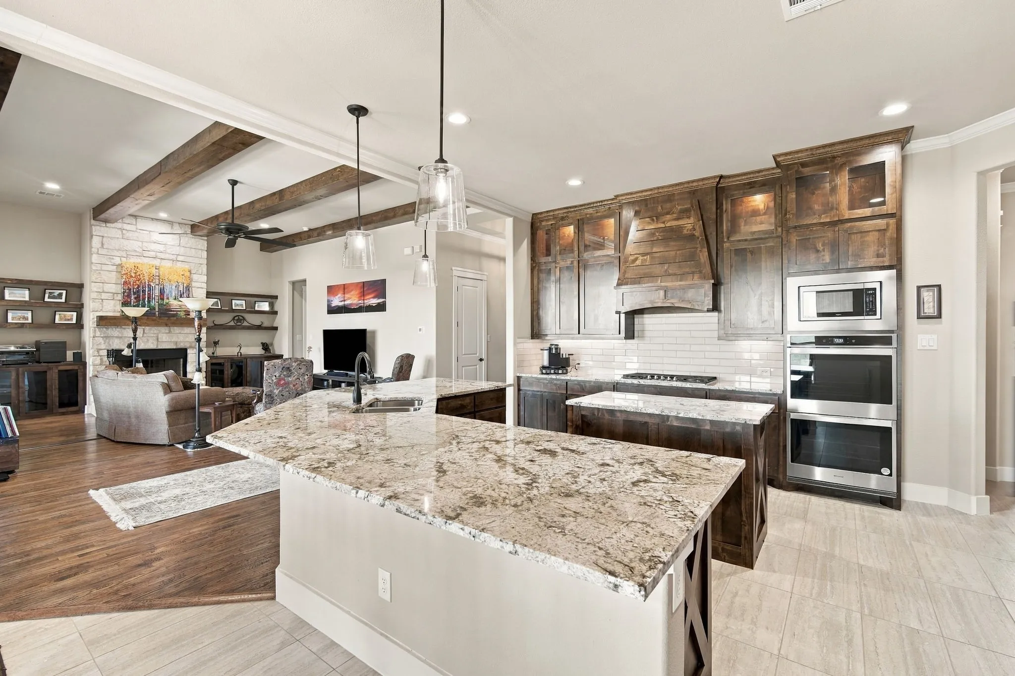 Kitchen features large island with a counter height bar, Custom decorative vent hood and lighted display cabinets to put your special pieces.