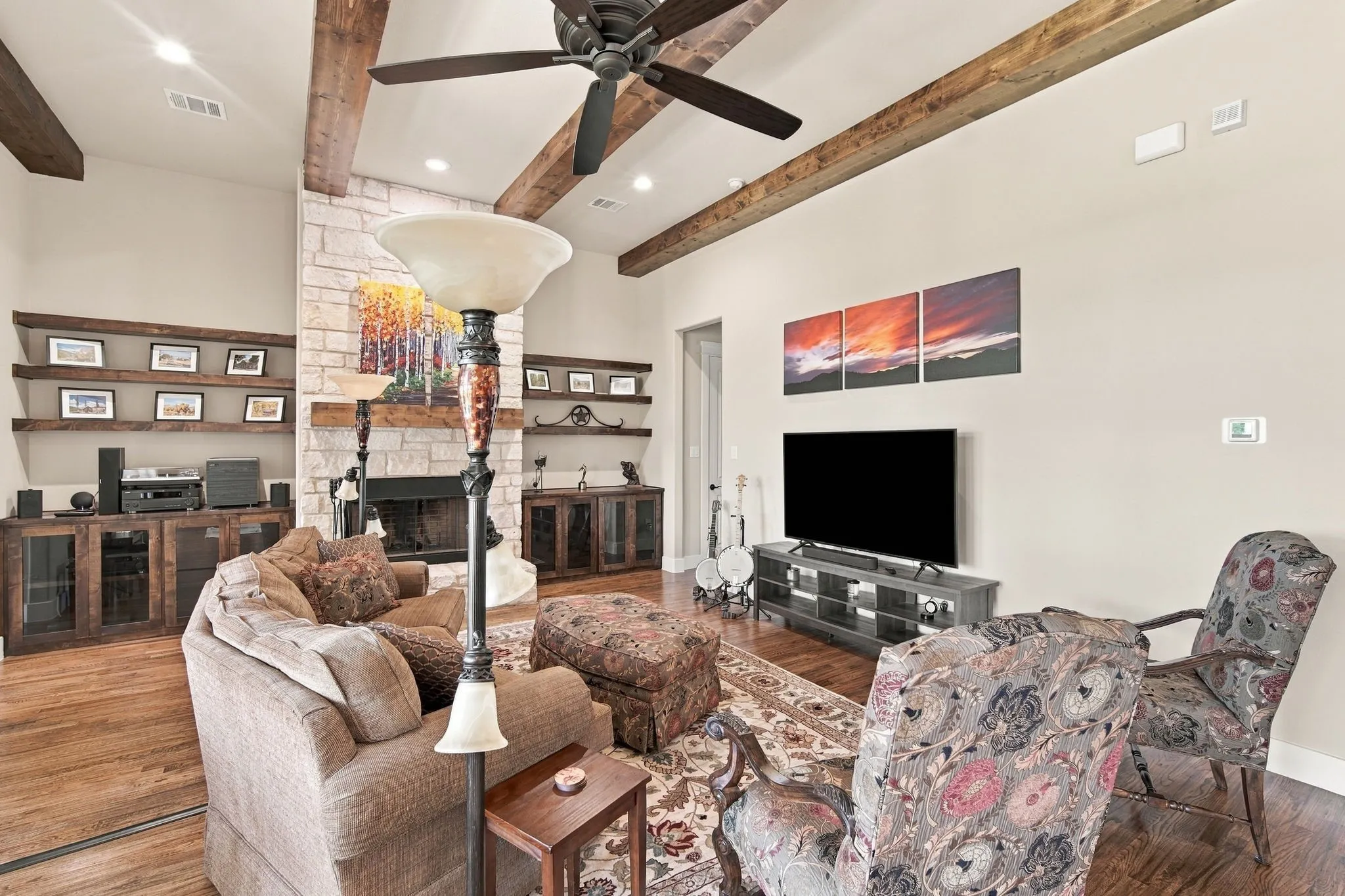 Alternate view of the living area showing more details on the glass front cabinets and recessed lighting.