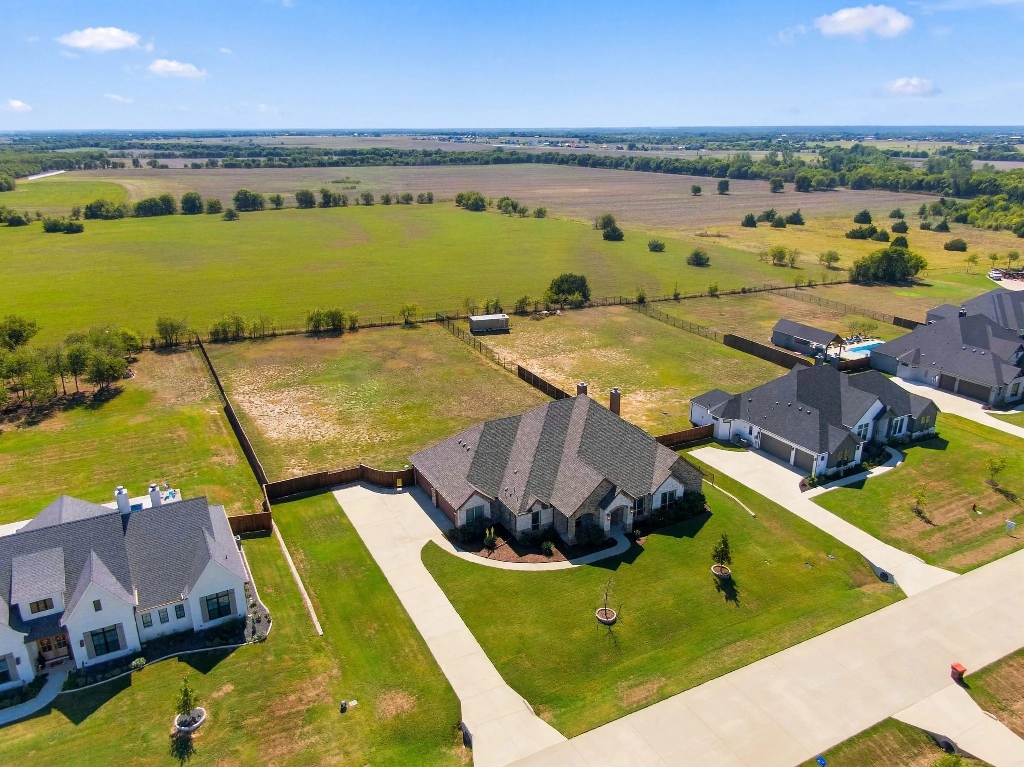 Long driveway with a double gate at the end.