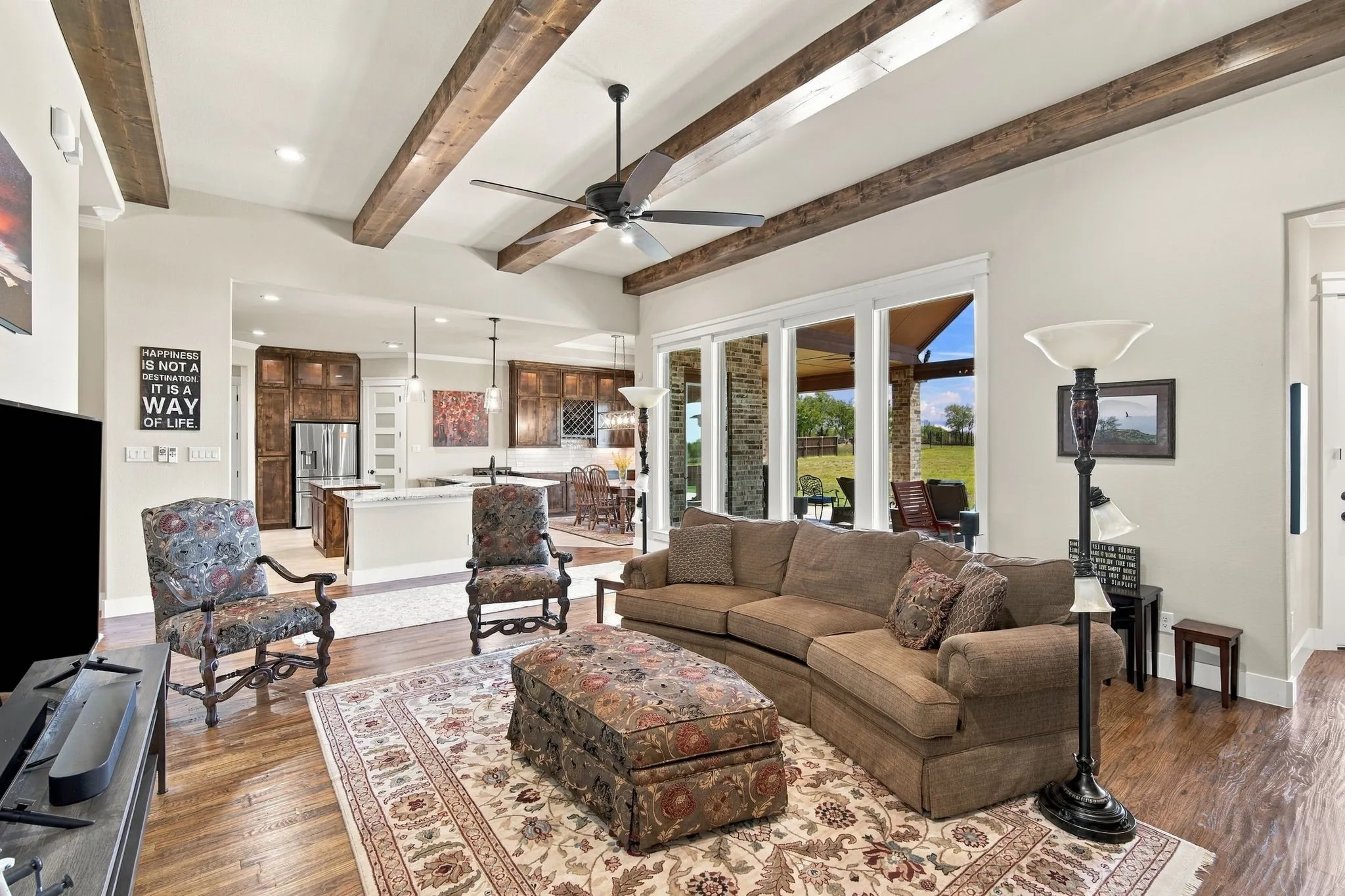 Open concept plan seamlessly flows the living room into the kitchen and dining space. The windows add great natural light & have Electric shades.