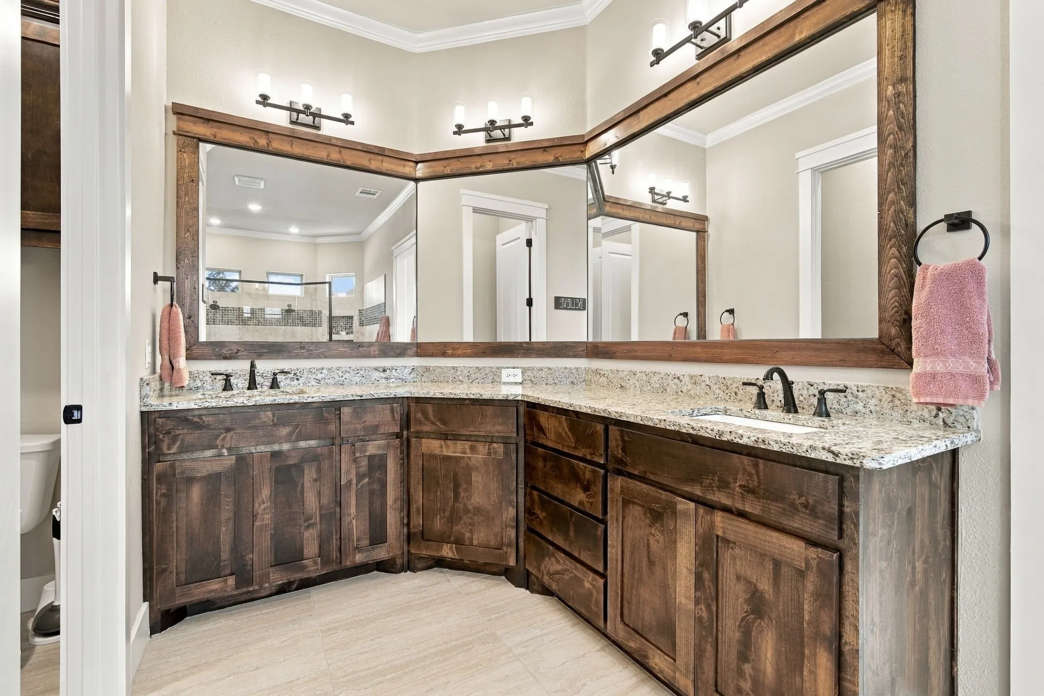 Plenty of space to get ready with the dual vanity with undermount sinks.  Separate water closet.