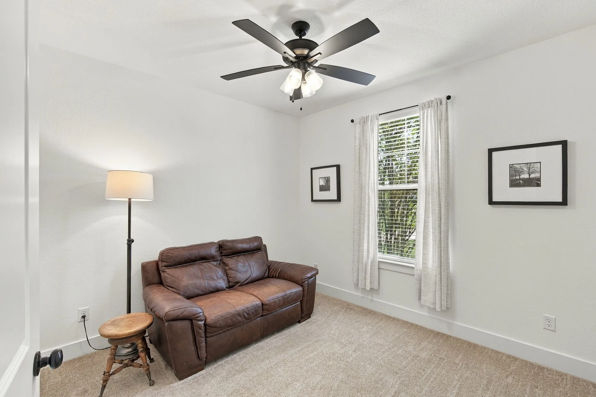 This bedroom has a good size closet with a ceiling fan and blinds.