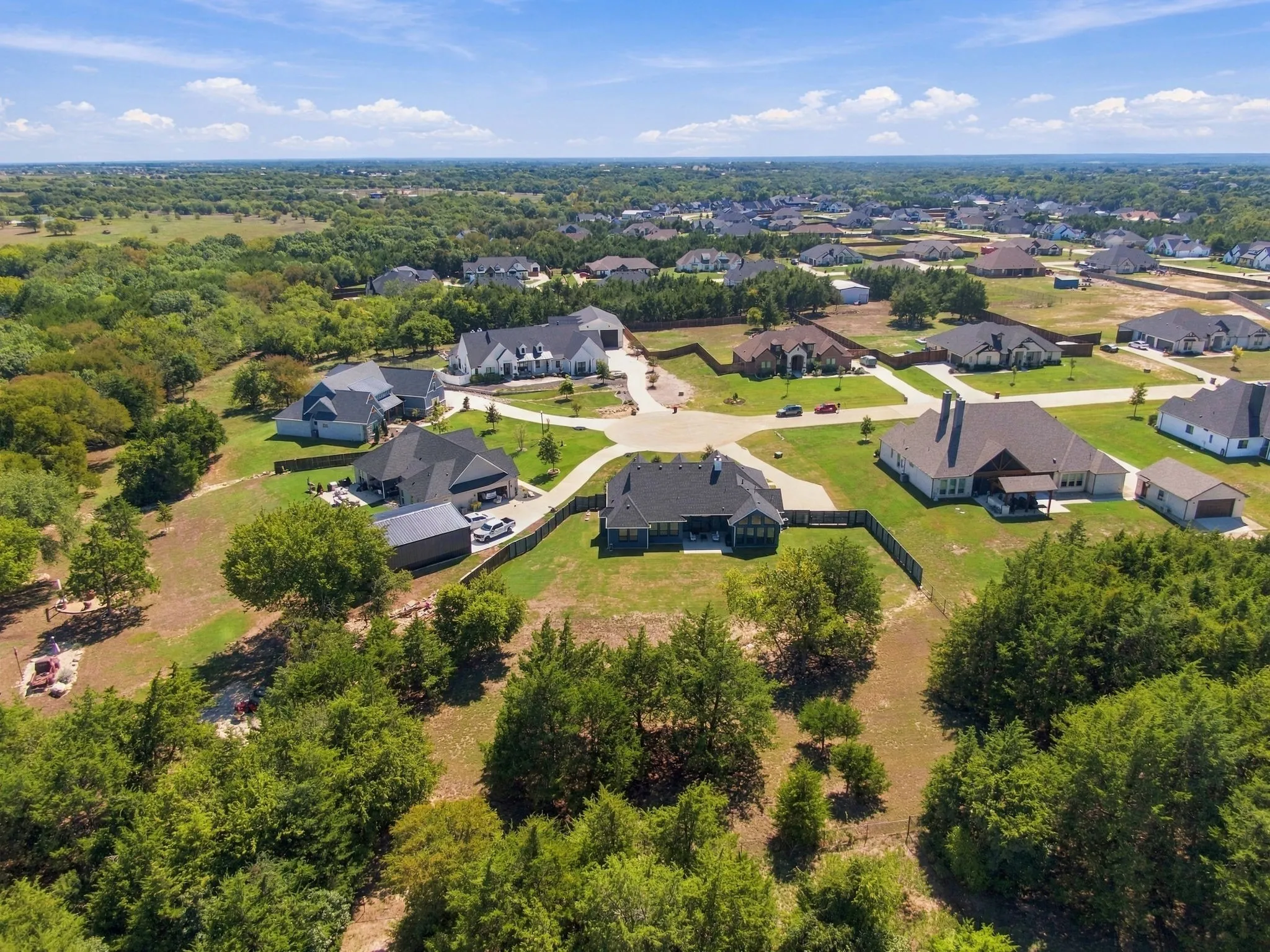 Expansive view of the home  and neighborhood with large lots and mature trees