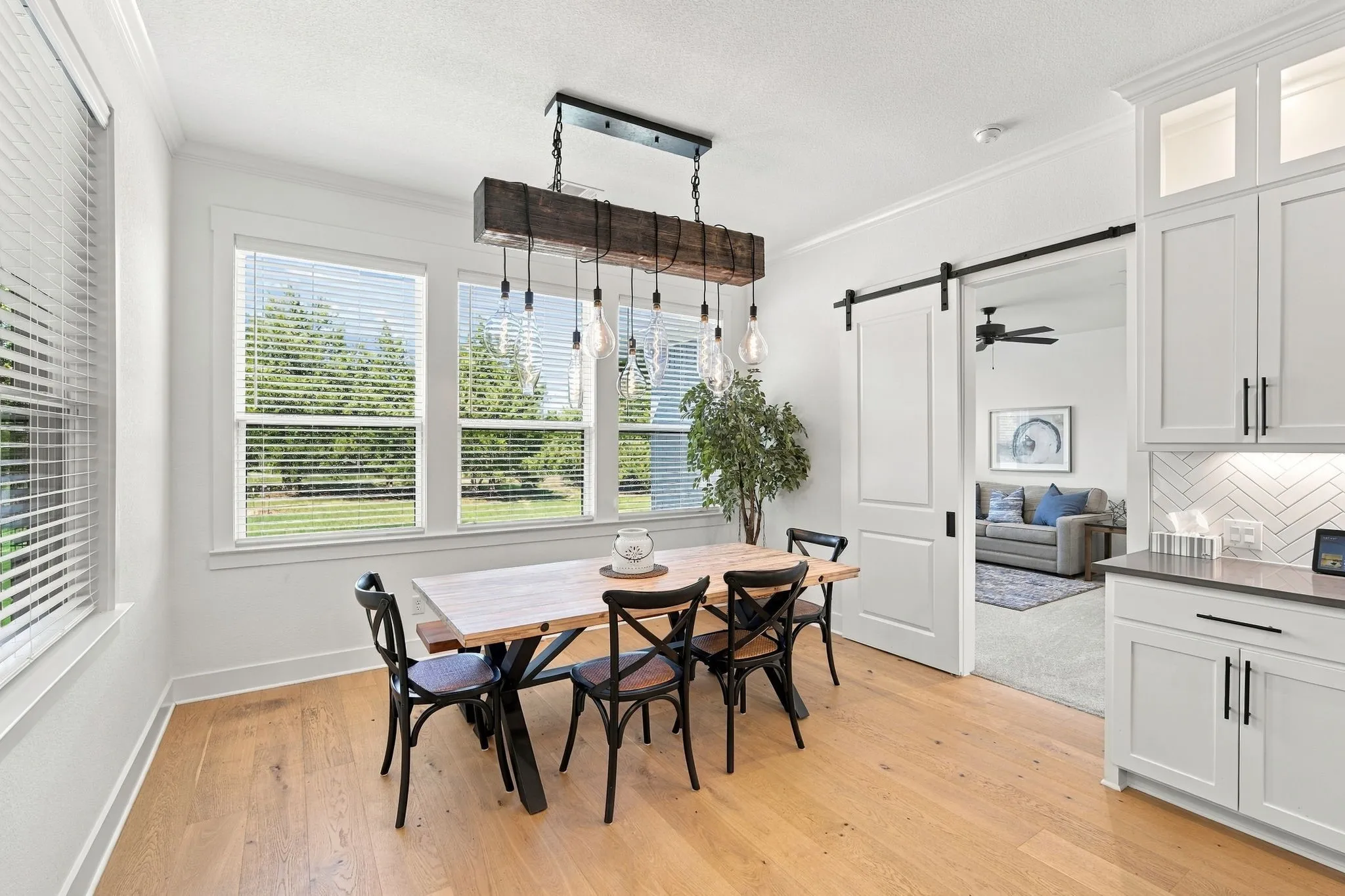 Love the view out the dining room window with lots of trees. The barn door leads to the second living room.
