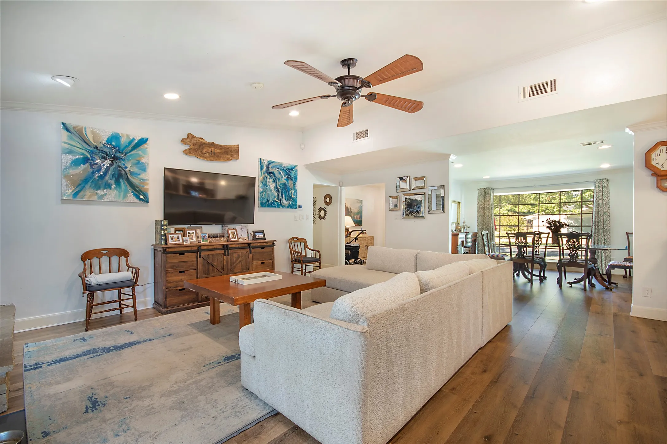 Recessed lighting, wood-finish flooring, and a ceiling fan with light fixture