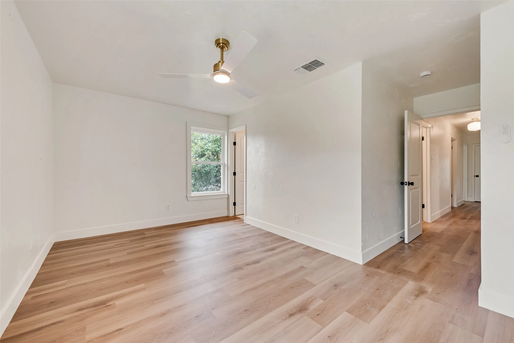 Additional primary bedroom view shows ample space for furnishings.