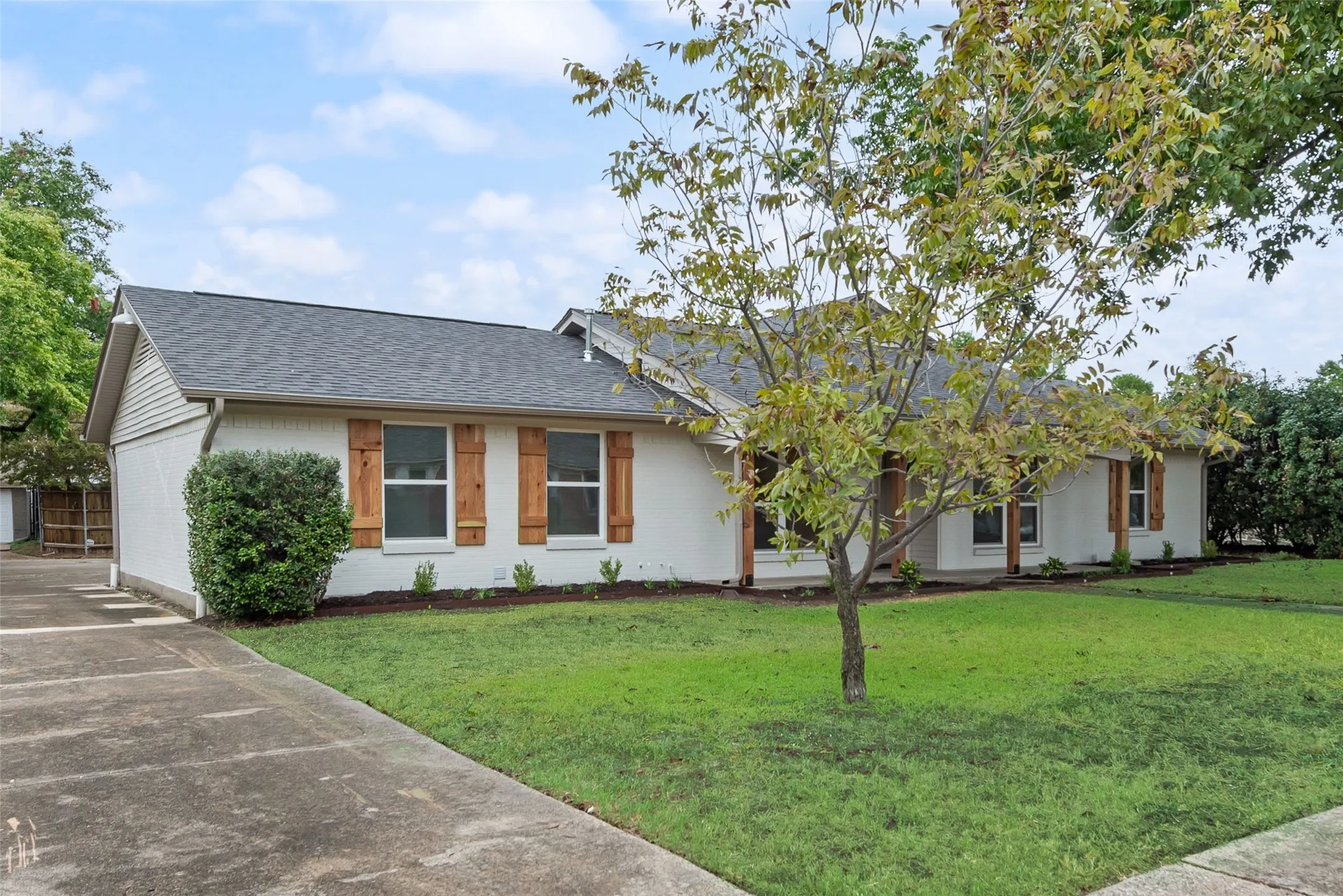 Refreshed exterior with new paint, mature trees, and inviting curb appeal.