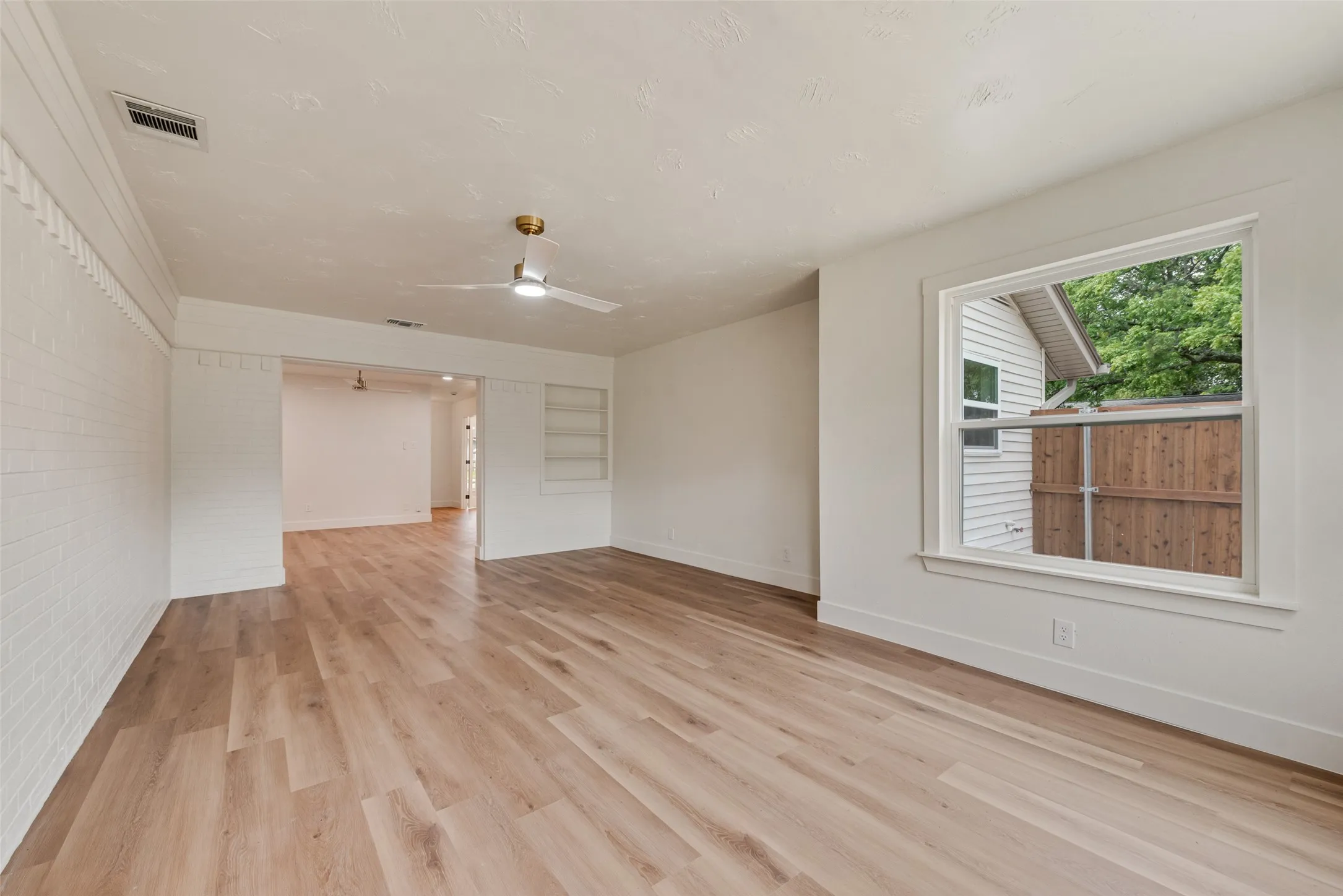 Additional family room view highlights the open layout and new windows.