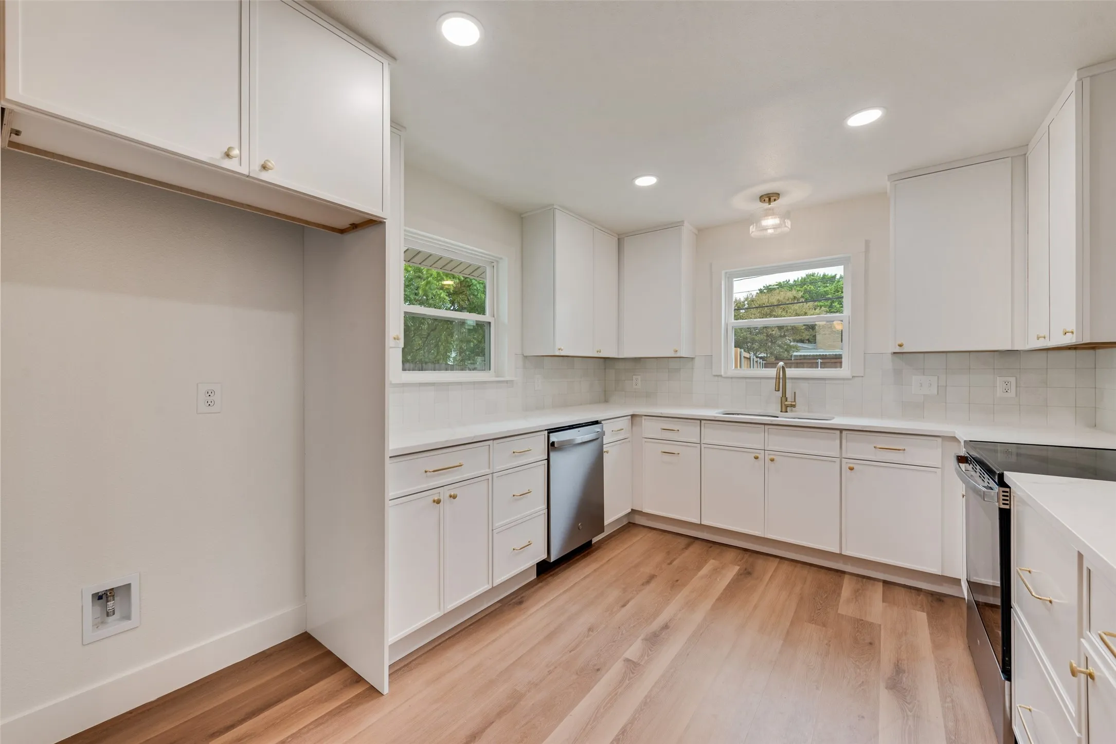 Additional kitchen view highlights abundant storage and natural light.