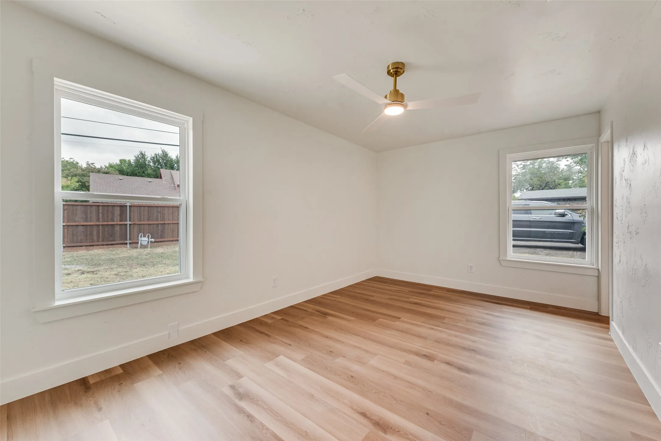 Bright primary suite with large windows and a generous, flexible layout.