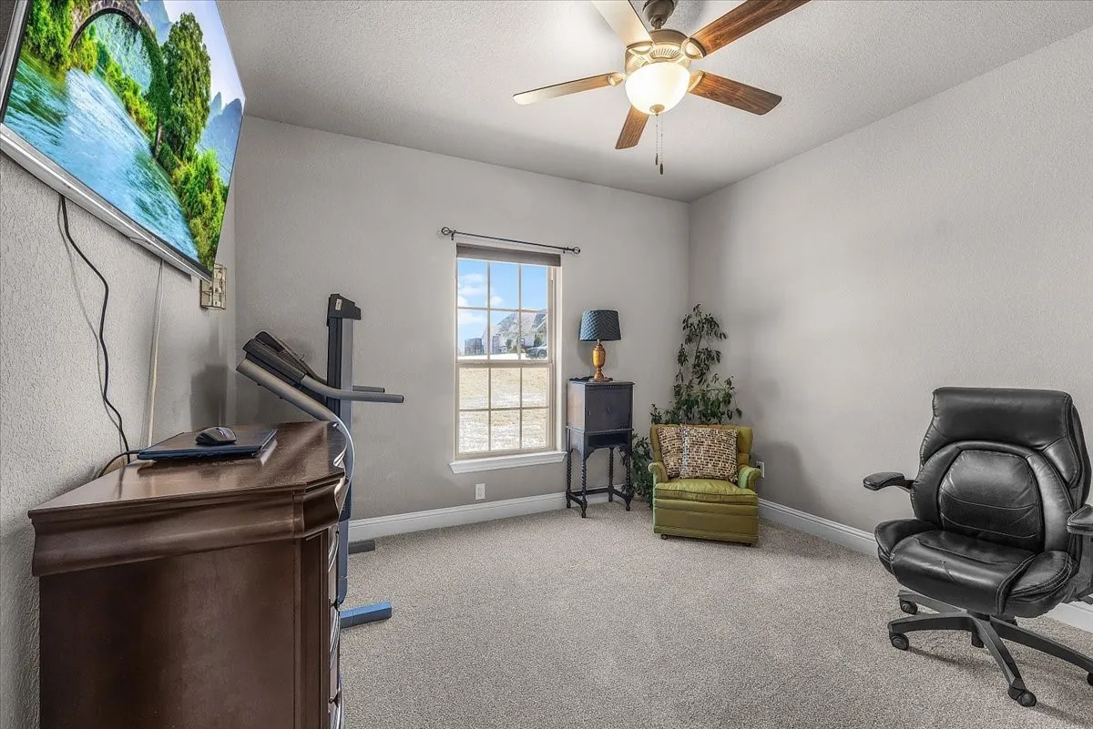 Bedroom: Comfortable bedroom features neutral finishes, plush new carpet, a ceiling fan, and a window providing natural light.