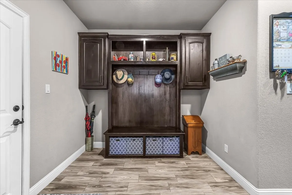 Drop Zone: Built-in drop zone provides a bench, overhead cabinetry, open shelving, and hooks for convenient everyday storage and organization.