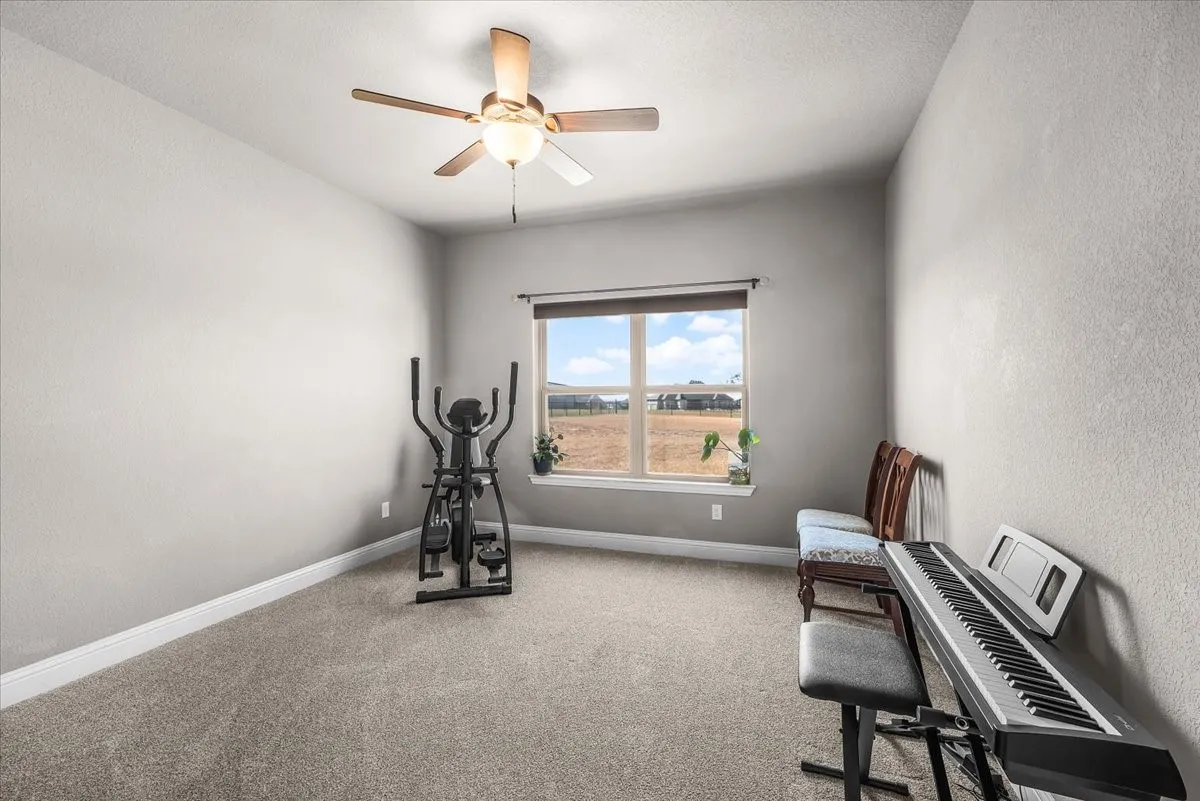 Bedroom: Comfortable bedroom features neutral finishes, plush new carpet, a ceiling fan, and a window providing natural light.