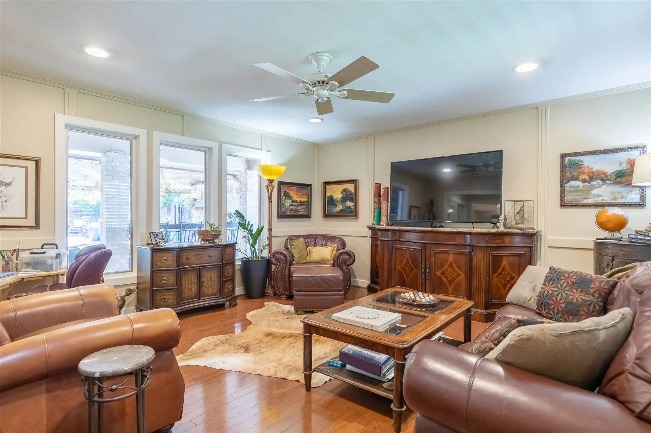 Hardwood-finish flooring, recessed lighting, and a ceiling fan