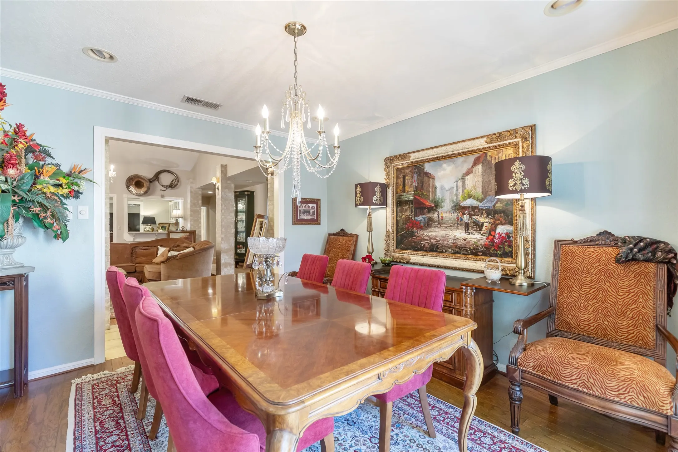 Formal dining area featuring hardwood flooring, crown molding, a crystal chandelier, and recessed lighting