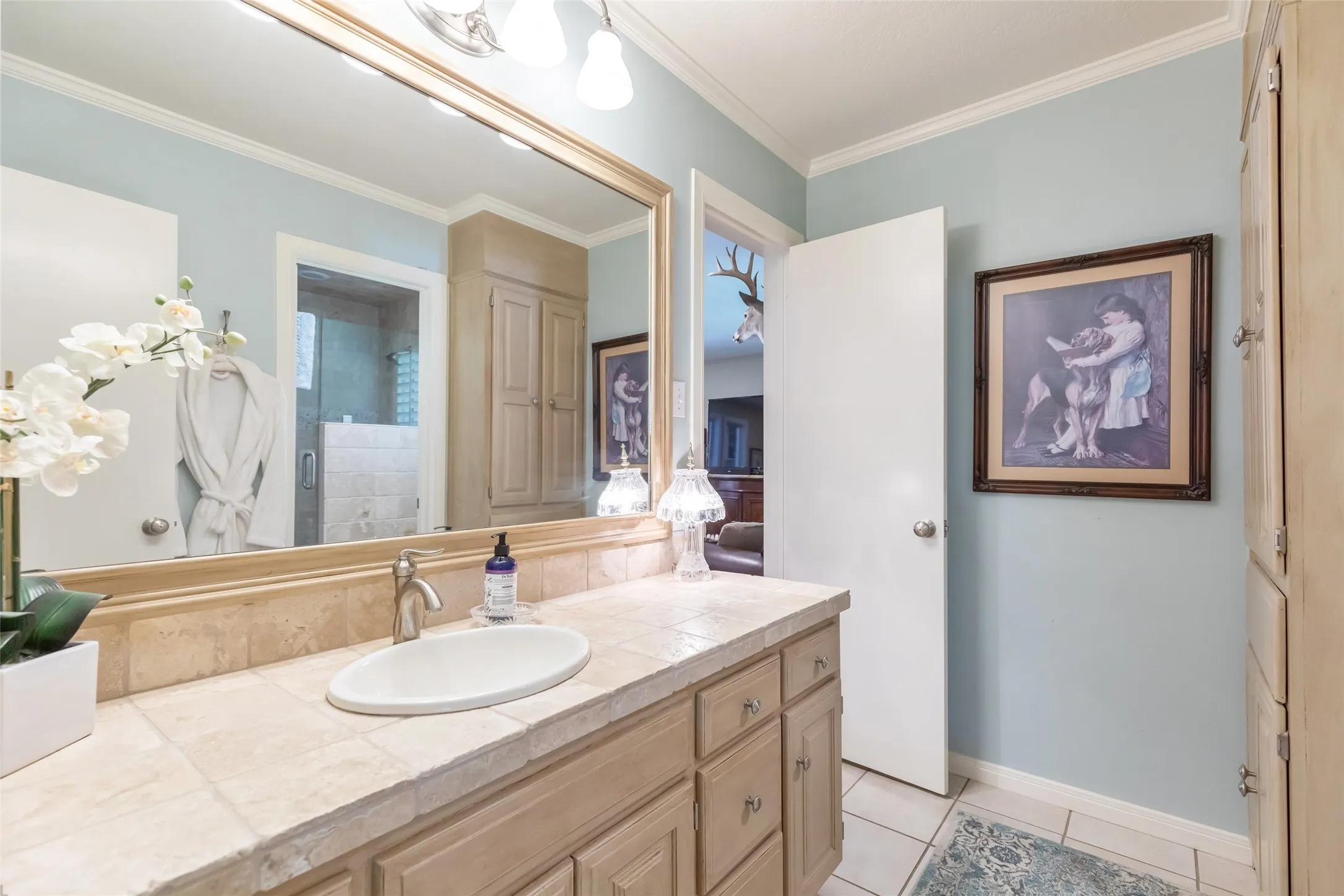 Wood-finish vanity with an undermount sink and brushed nickel faucet