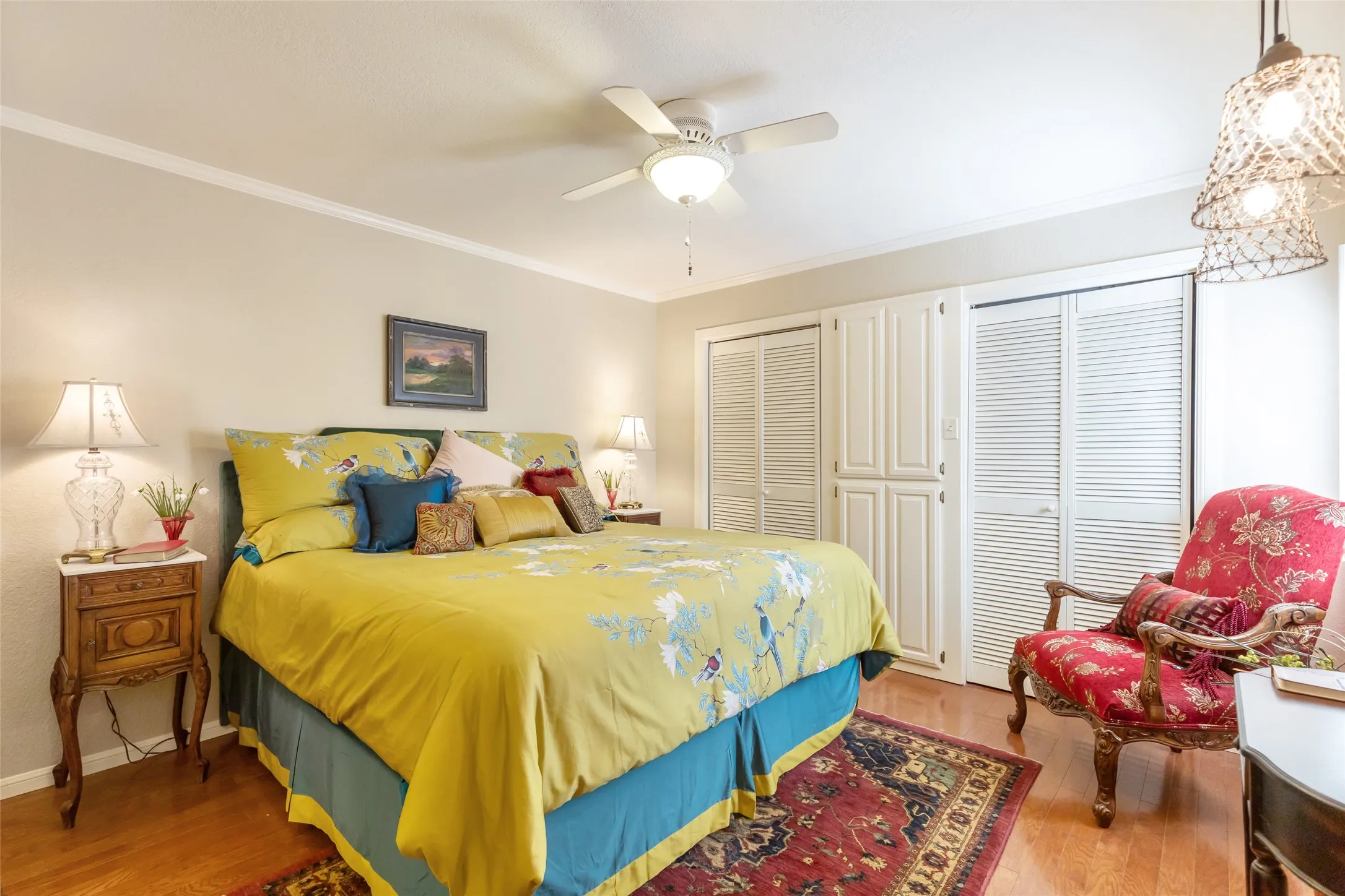 Hardwood flooring throughout, crown molding, and a ceiling fan with integrated lighting