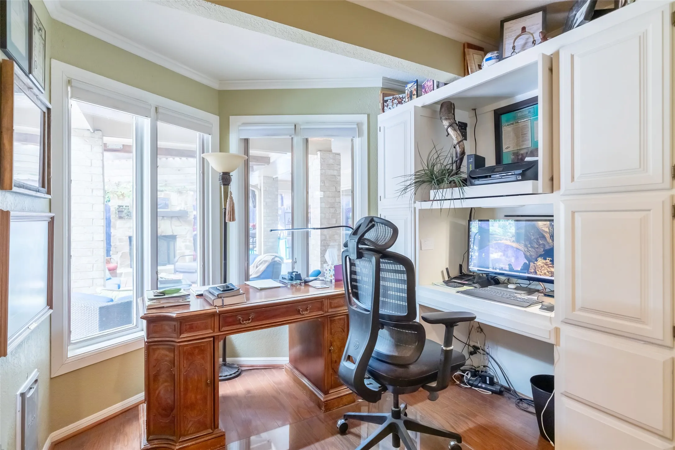 Built-in white cabinetry, integrated desk space, and wood-finish flooring