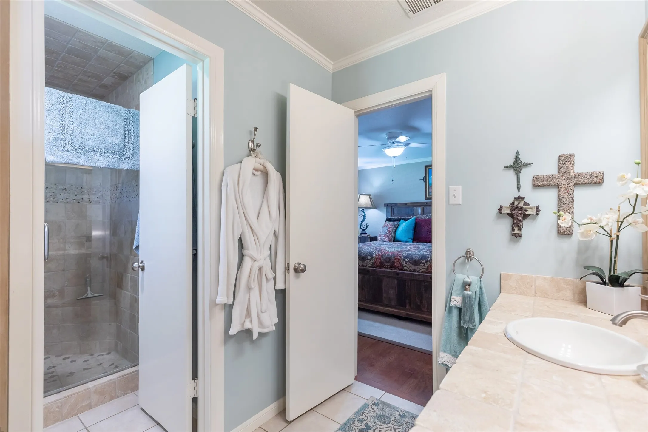 Glass-enclosed shower with tiled walls and floor