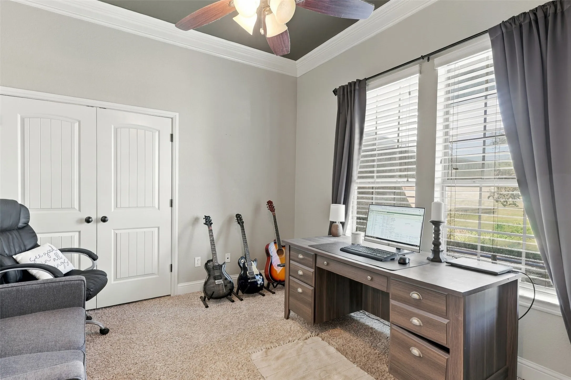 Home Office or 4th bedroom: Features a tray ceiling, double-door closet, and large windows overlooking the exterior.