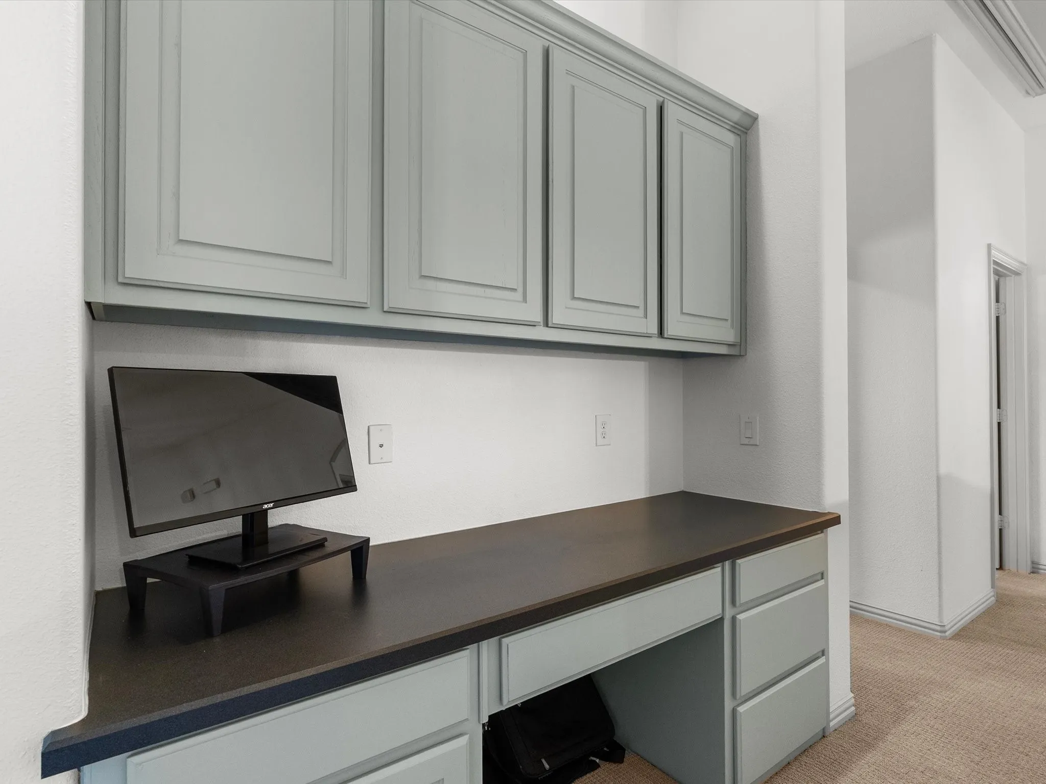 Upstairs study space with desk and storage cabinets