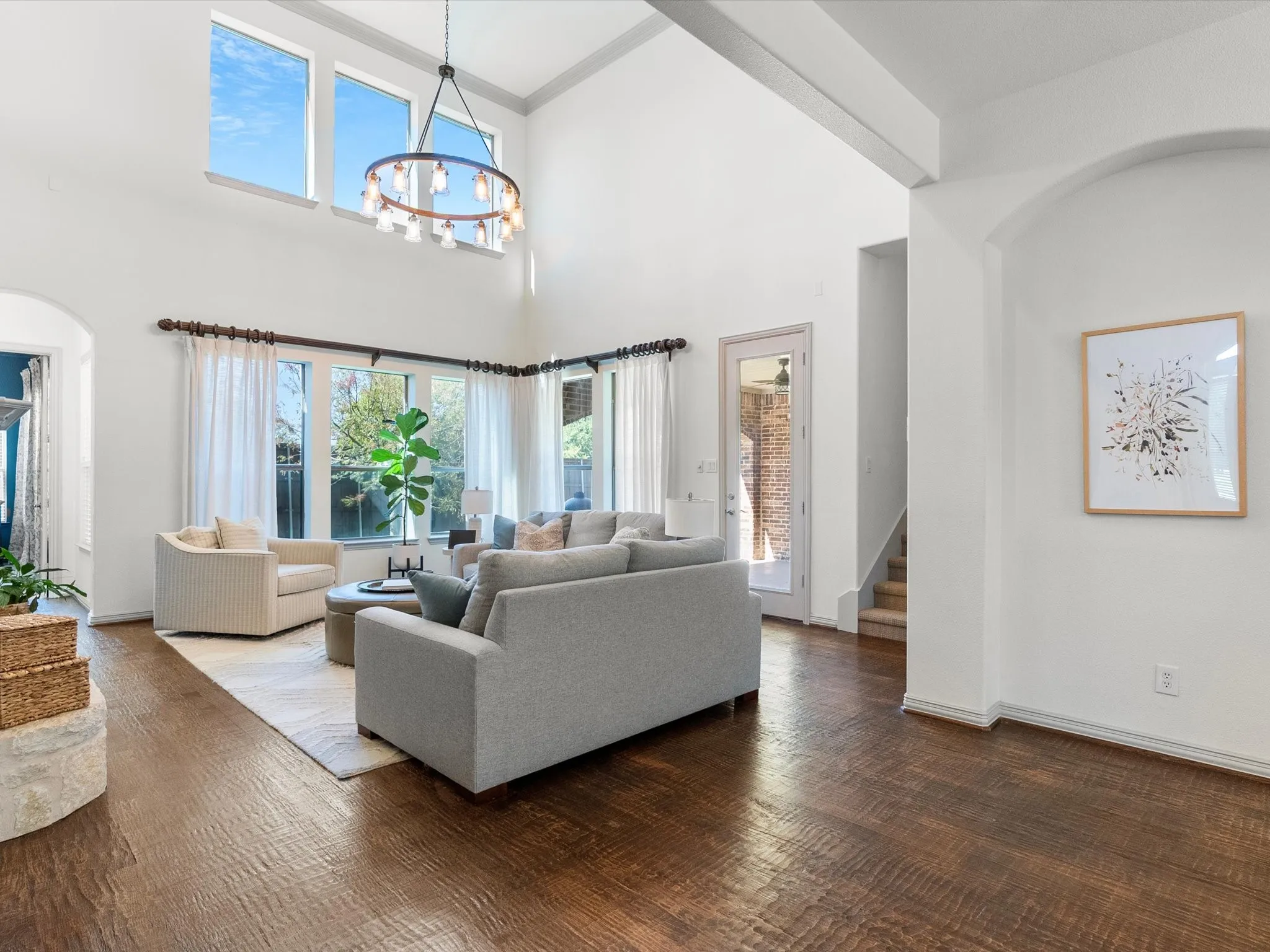 Primary living space with soaring ceilings and updated lighting