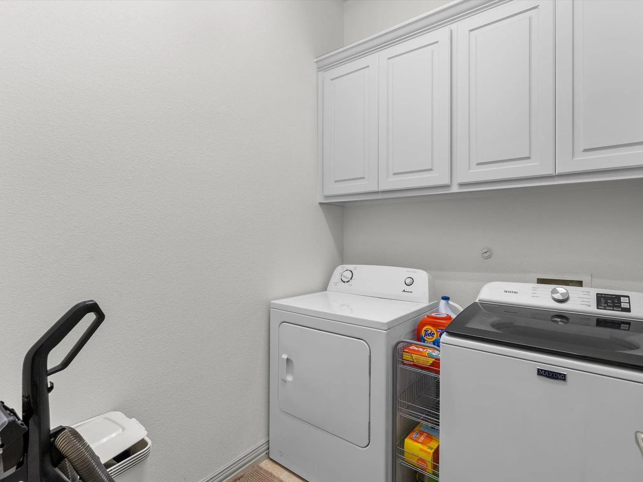 First-level laundry room with storage cabinets