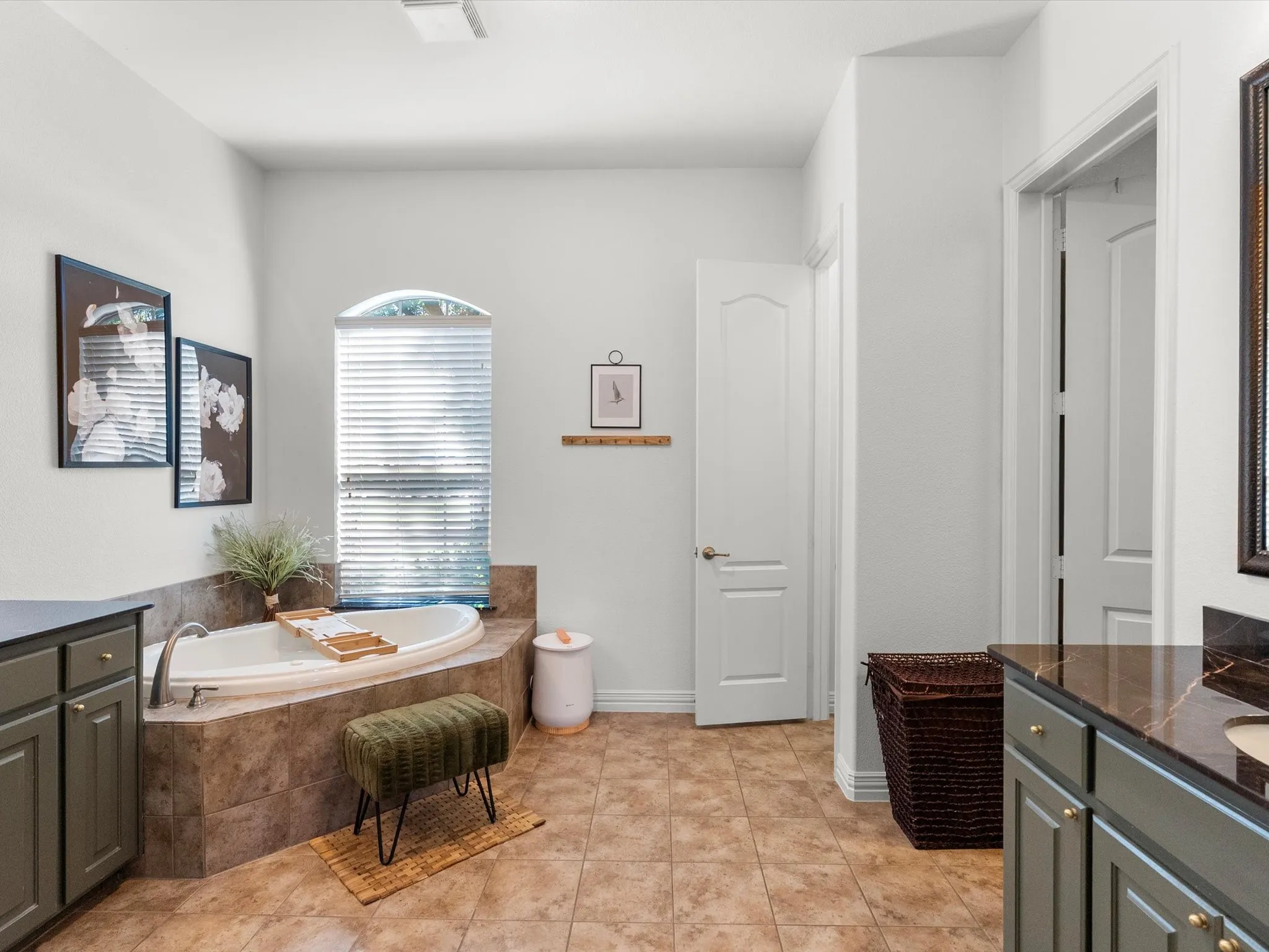 Ensuite primary bathroom with dual vanities and private toilet closet