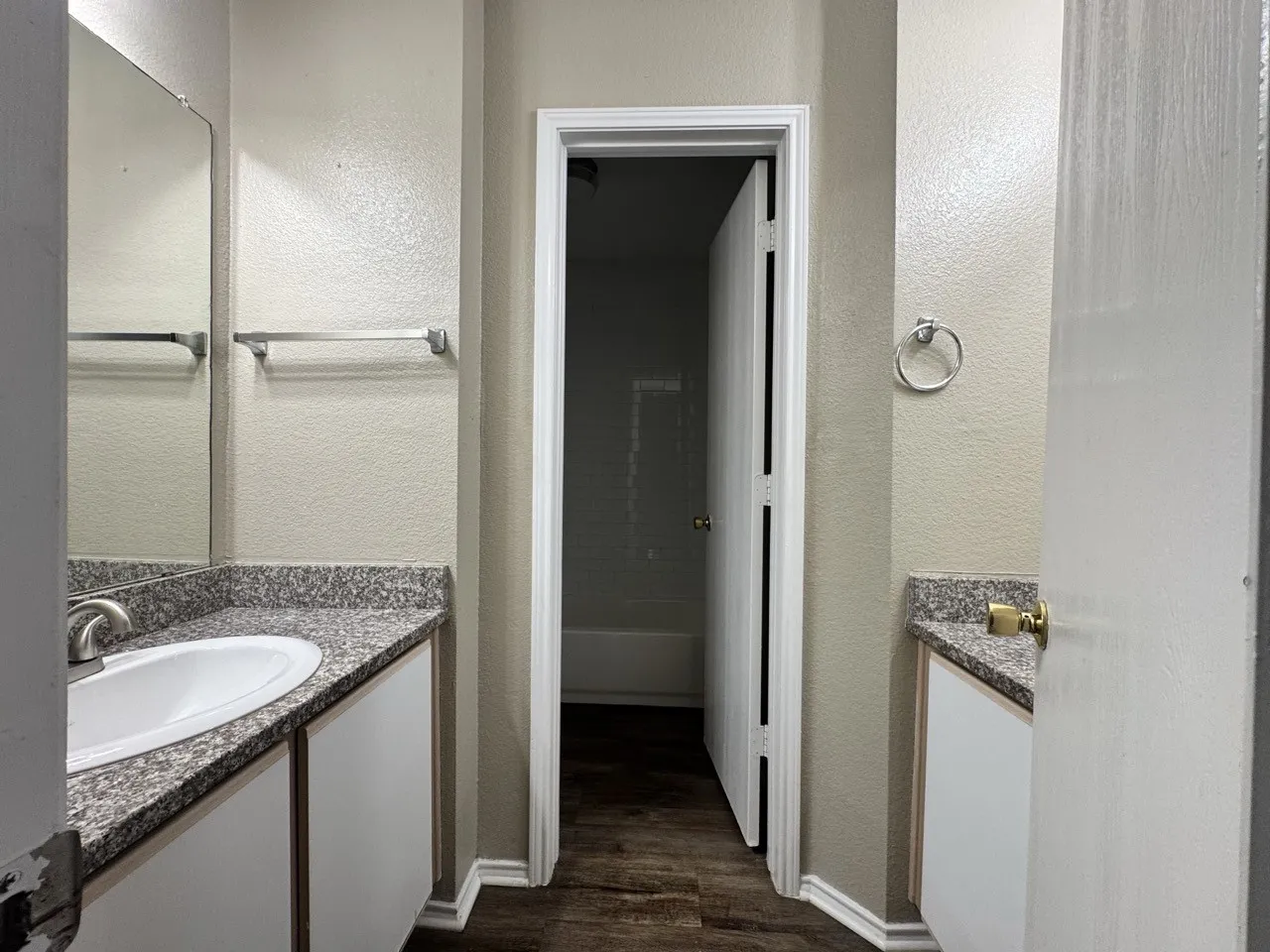Upstairs bathroom. Dual vanity setup with stone-finish countertops and integrated sinks