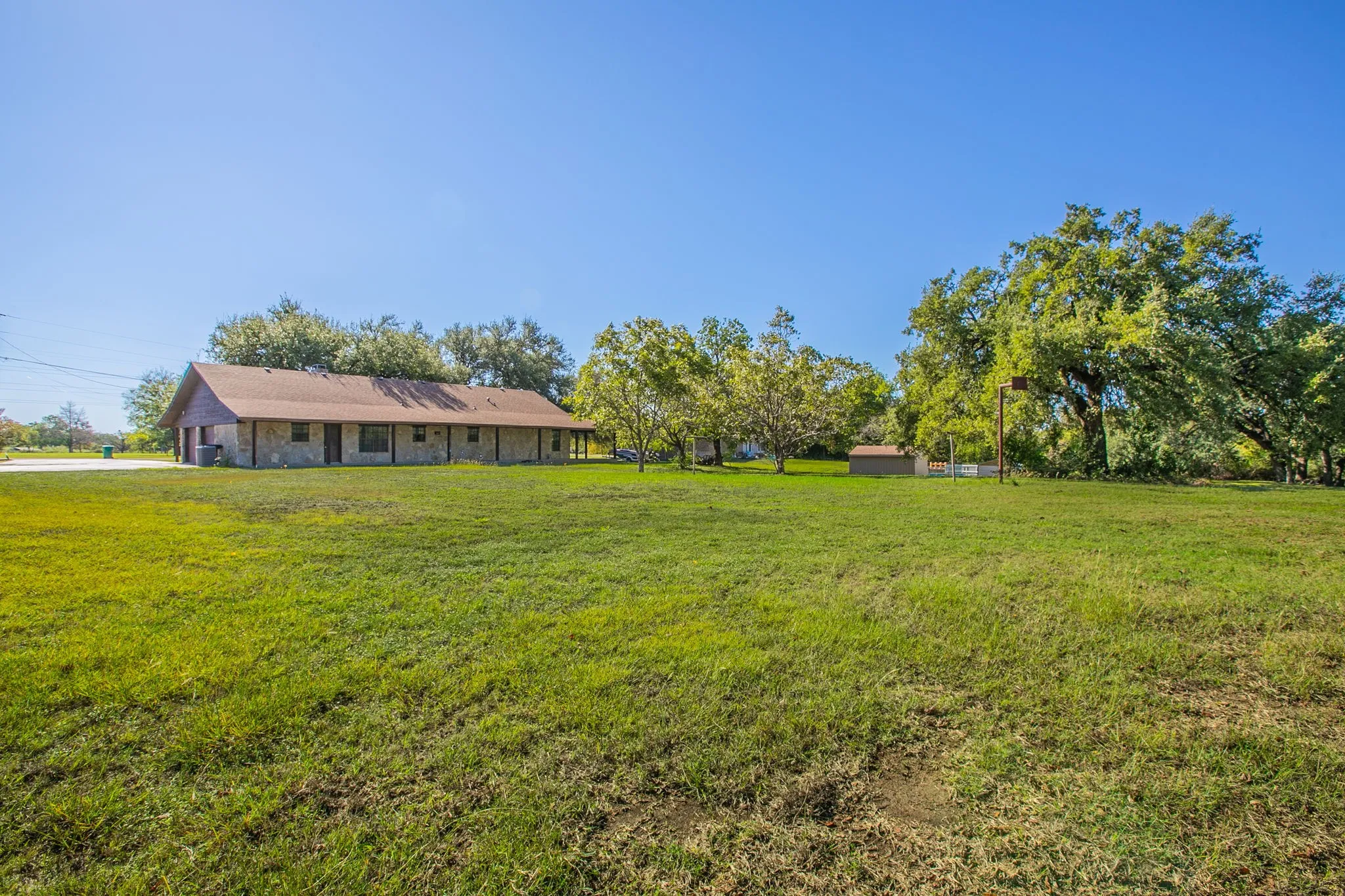 Expansive  lawn.  Property is 1.58 acres according to MCAD.  Buyers confirm! This view is from the shore line of the lake looking back at the home.