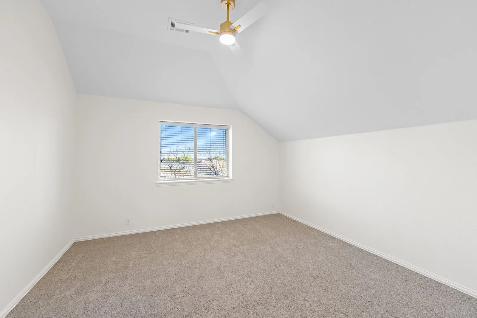 Vaulted ceiling with a contemporary ceiling fan, window with horizontal blinds, and neutral carpeting