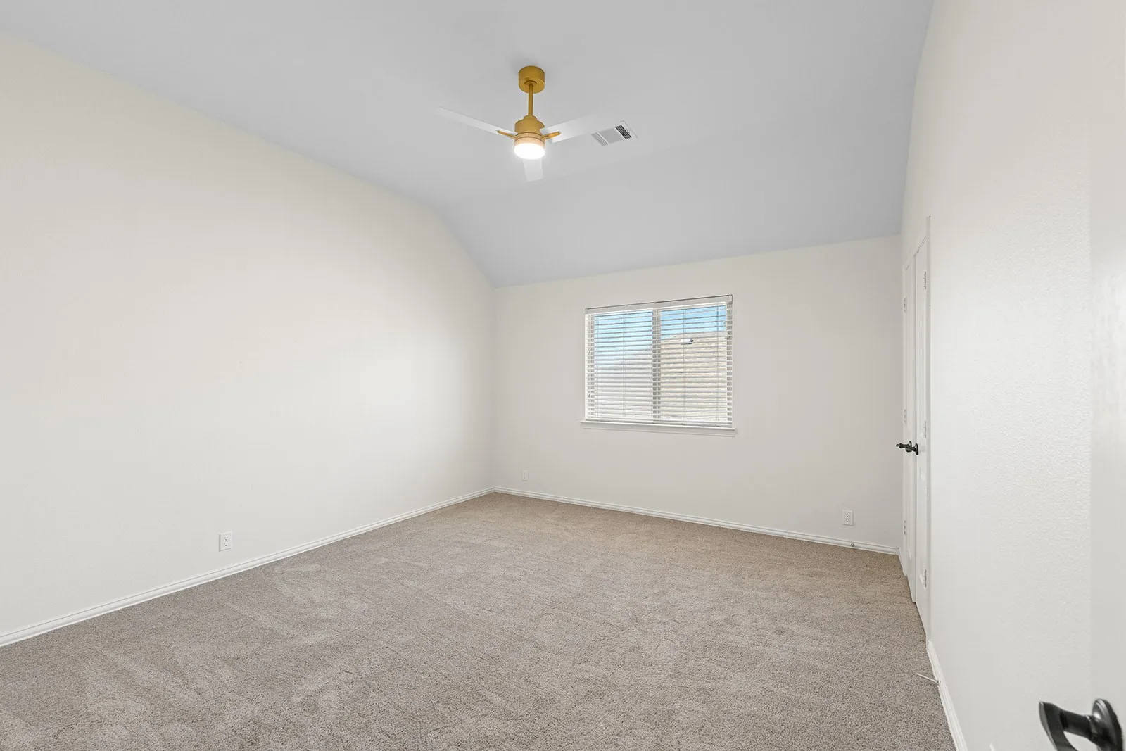 Vaulted ceiling with a ceiling fan, neutral wall finishes, carpeted flooring, and a window with blinds