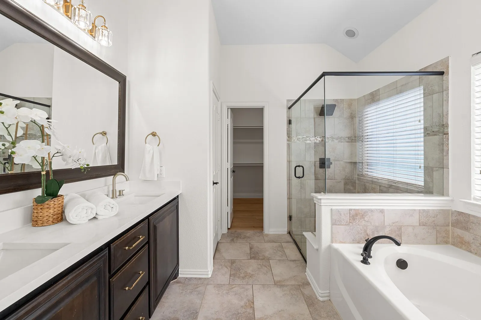 Dual vanity with undermount sinks and dark wood cabinetry