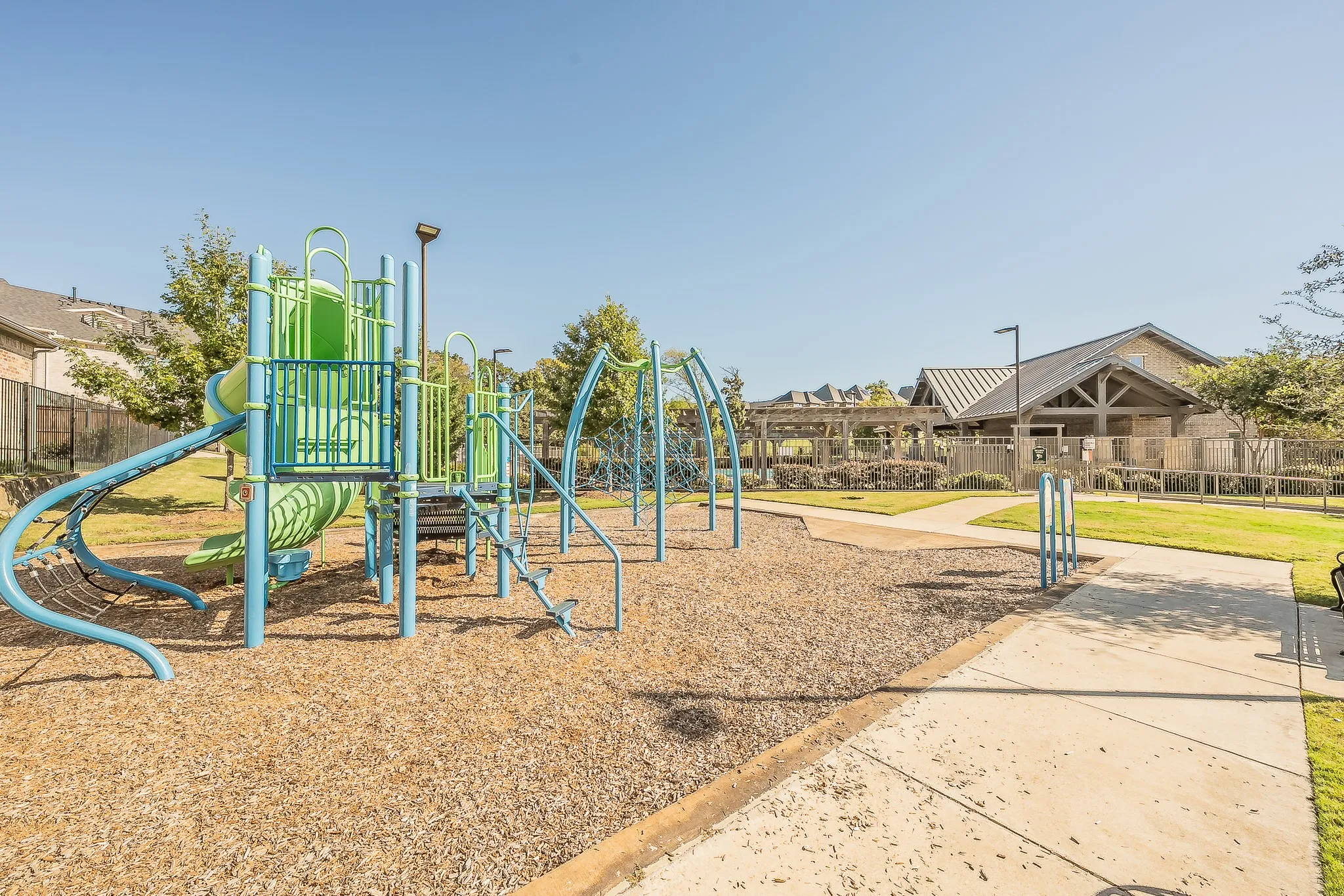 Community playground featuring multiple slides and climbing structures