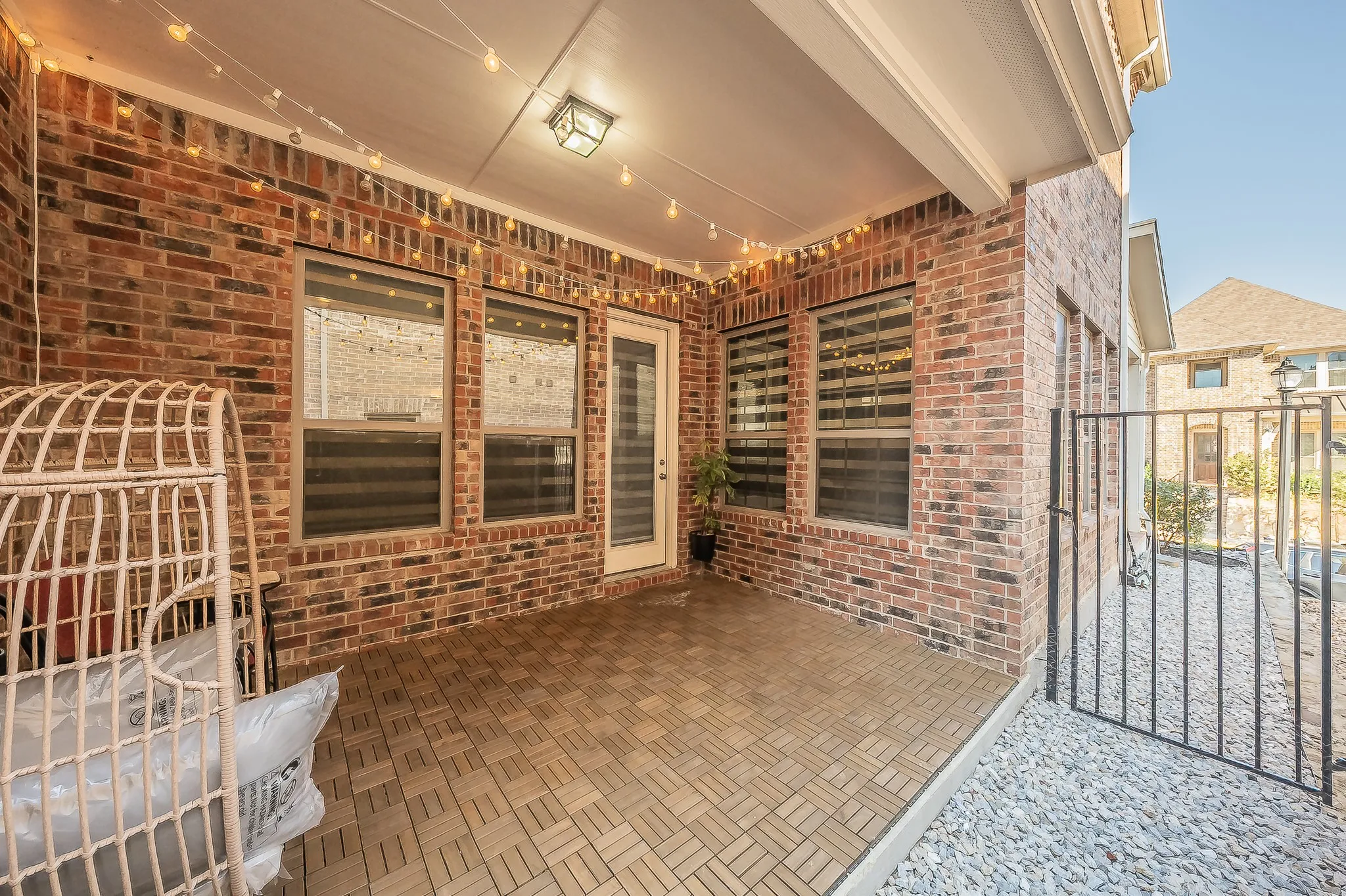 Covered outdoor patio opens to a private small low maintenance outdoor space