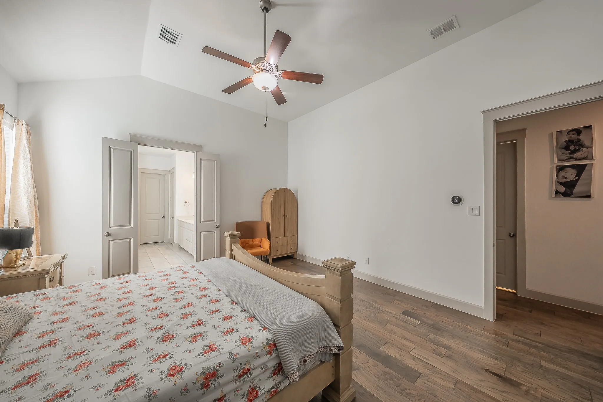 Spacious first floor primary bedroom features 2 separate walk-in closets and an ensuite bathroom with soaking tub and shower