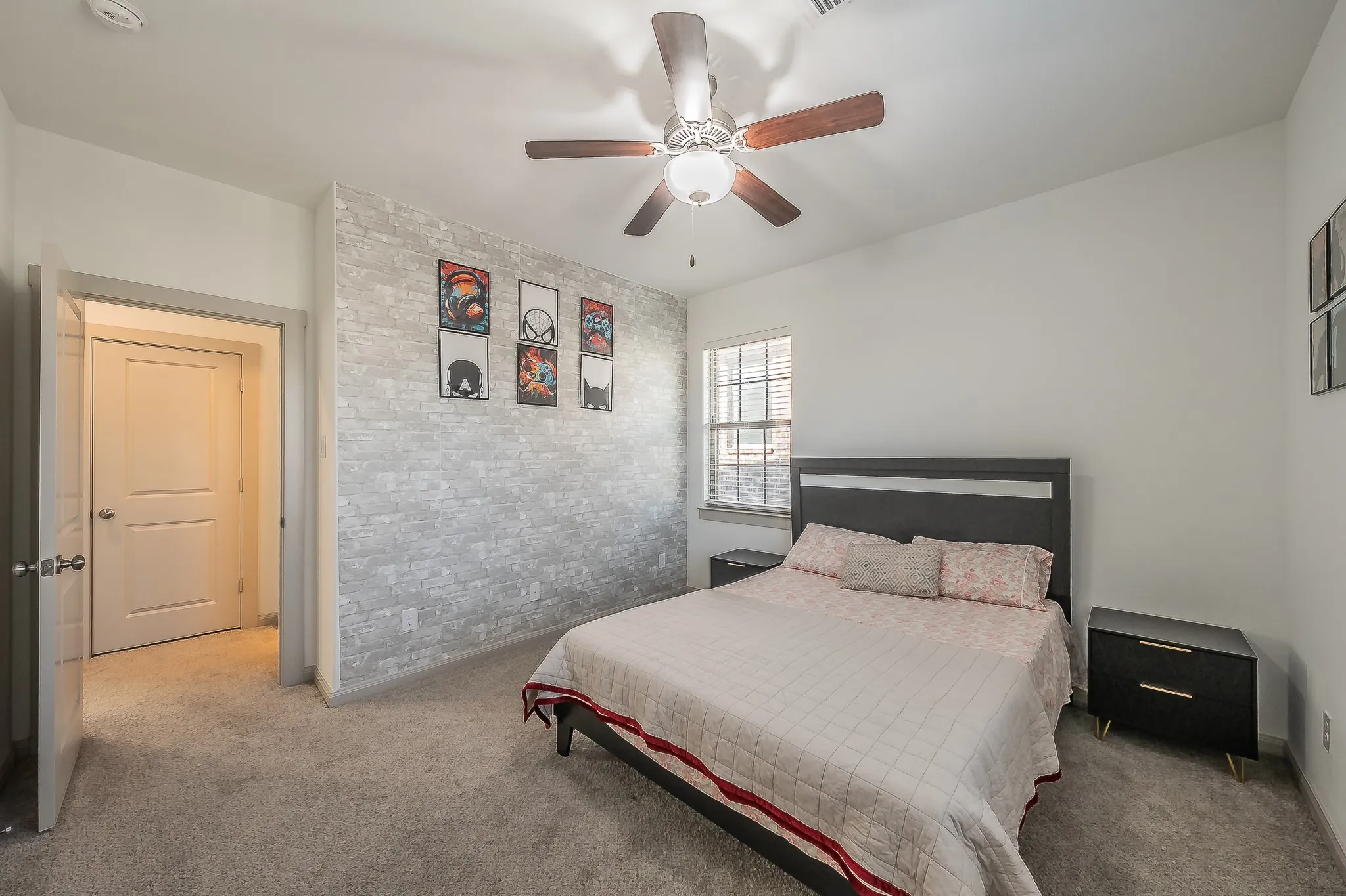 Second of two second floor bedrooms features an accent wall and carpeted flooring