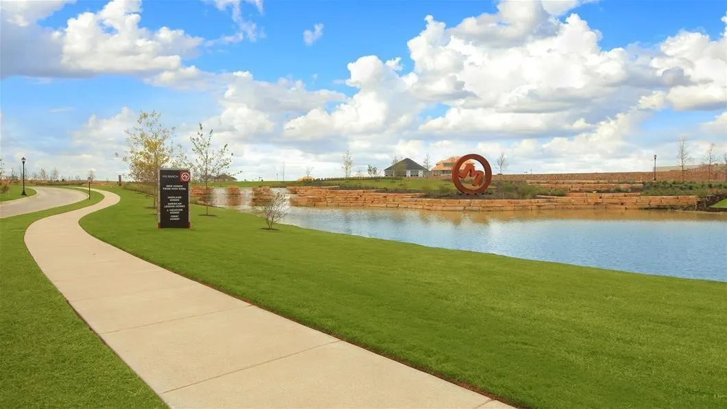 Winding paved pathway bordered by manicured lawn