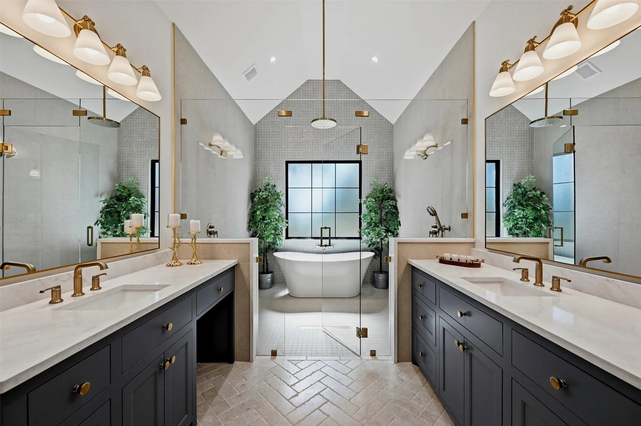 Dual vanities with undermount sinks, bronze fixtures, and white countertops