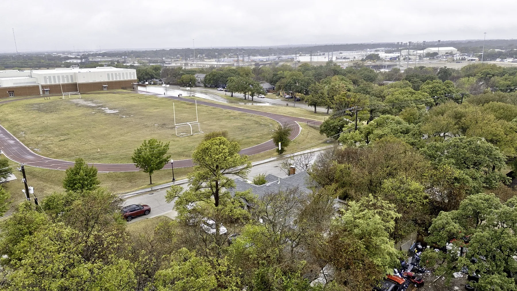Elevated view over the treetops from the property toward the school track and field across Craig St
