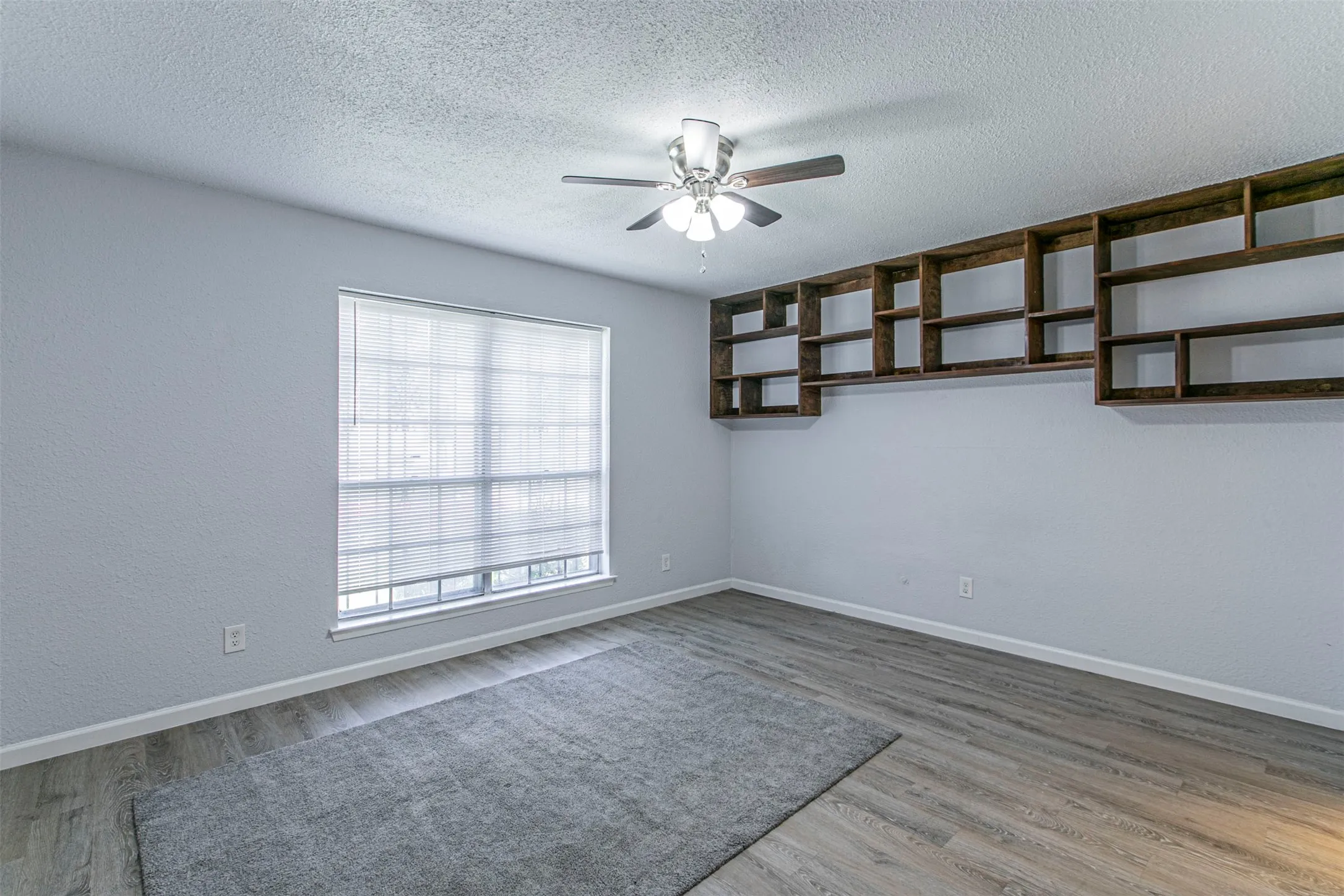 Bedroom 1 unfurnished  featuring light wood-style floors and a ceiling fan